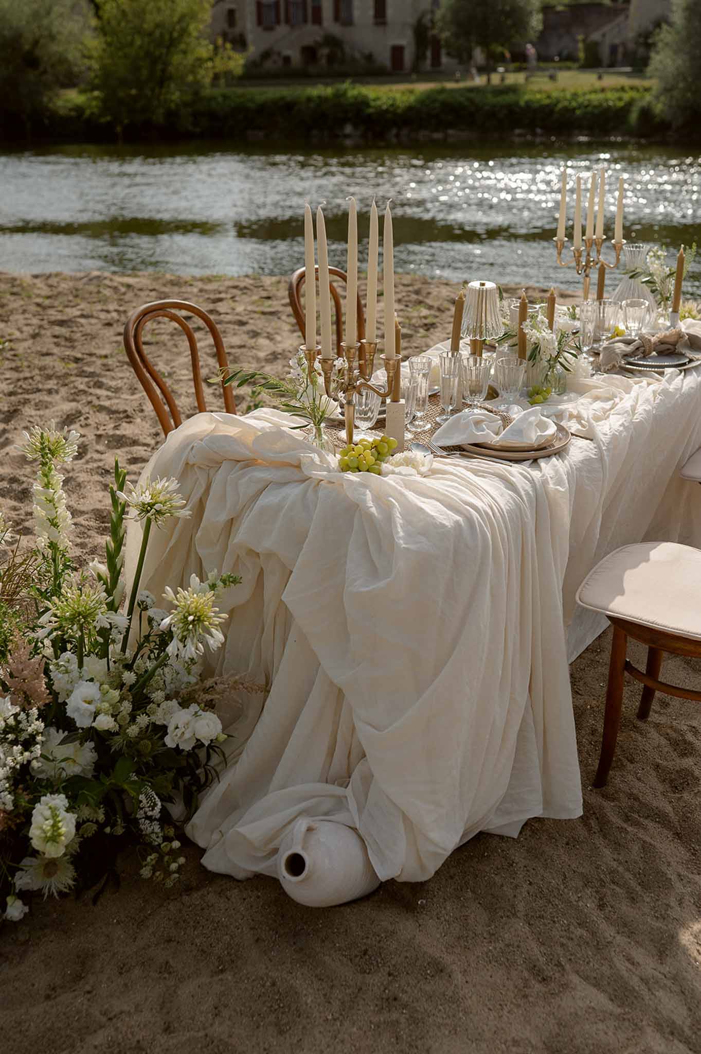 Full lakeside tablescape with wildflowers and village at Plage d'Apremont-sur-Allier