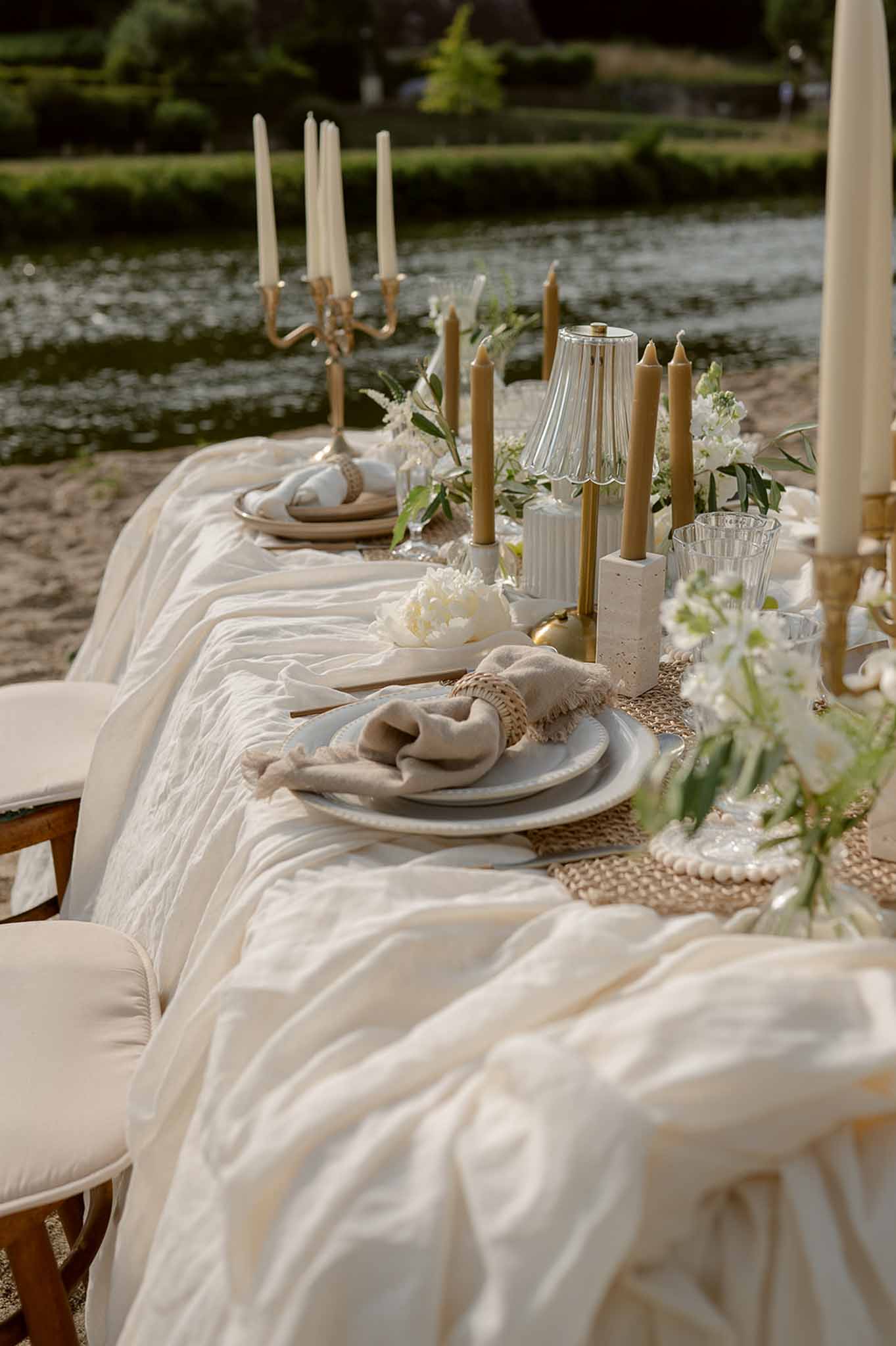 Full reception table with gold candelabras and river view at Plage d'Apremont-sur-Allier