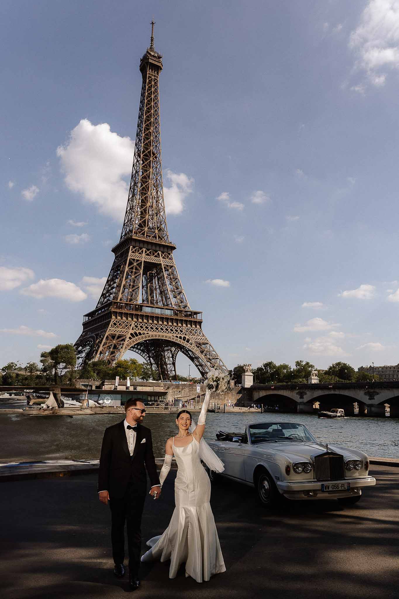 Bride and groom walking hand in hand in Paris