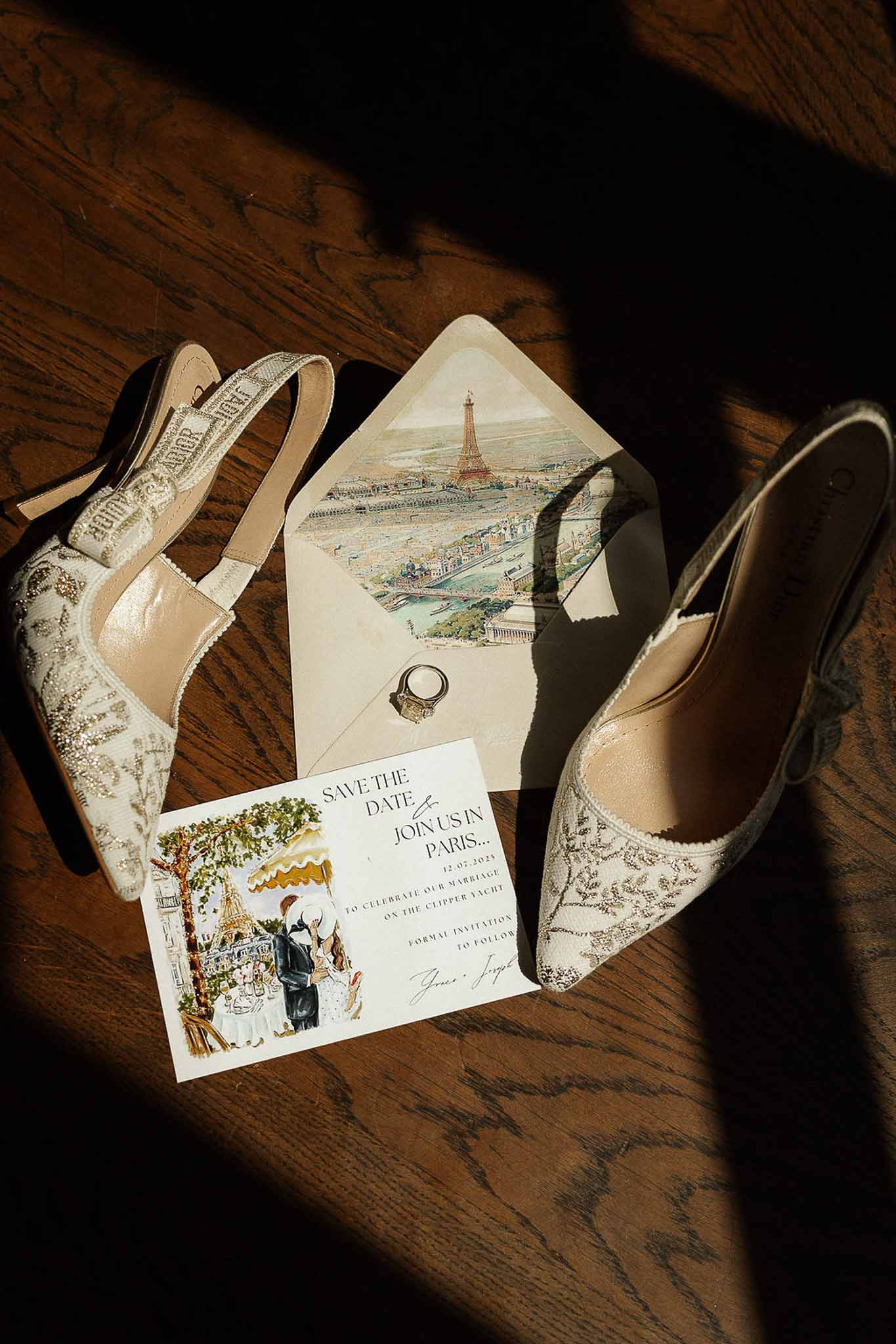 Paris-themed save-the-date with Eiffel Tower illustration, Dior slingback heels, and gold ring