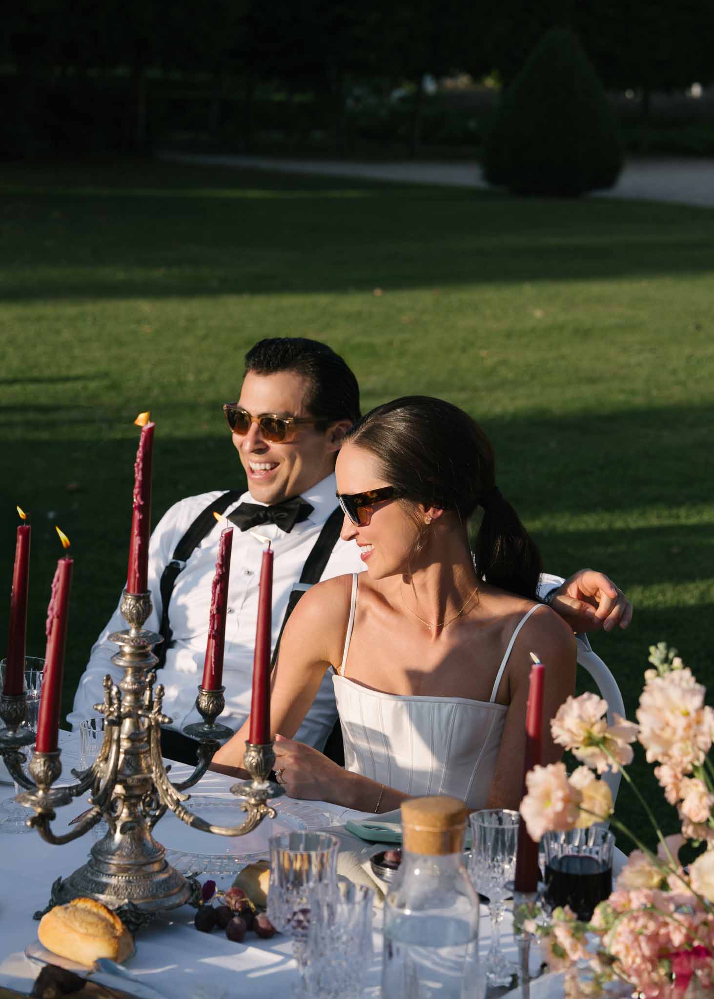 Wedding reception table setting in a garden with white roses