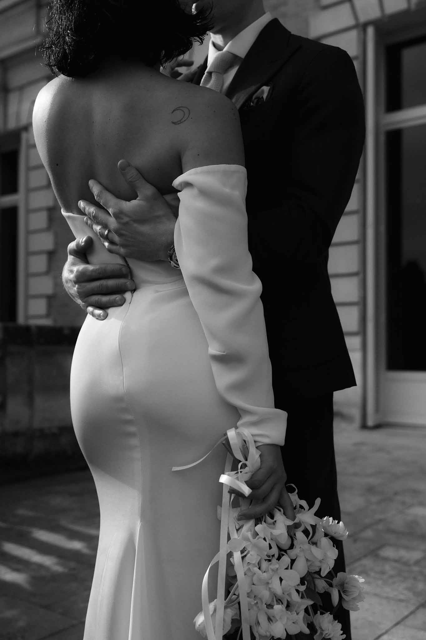 Black and white photo of bride and groom kissing