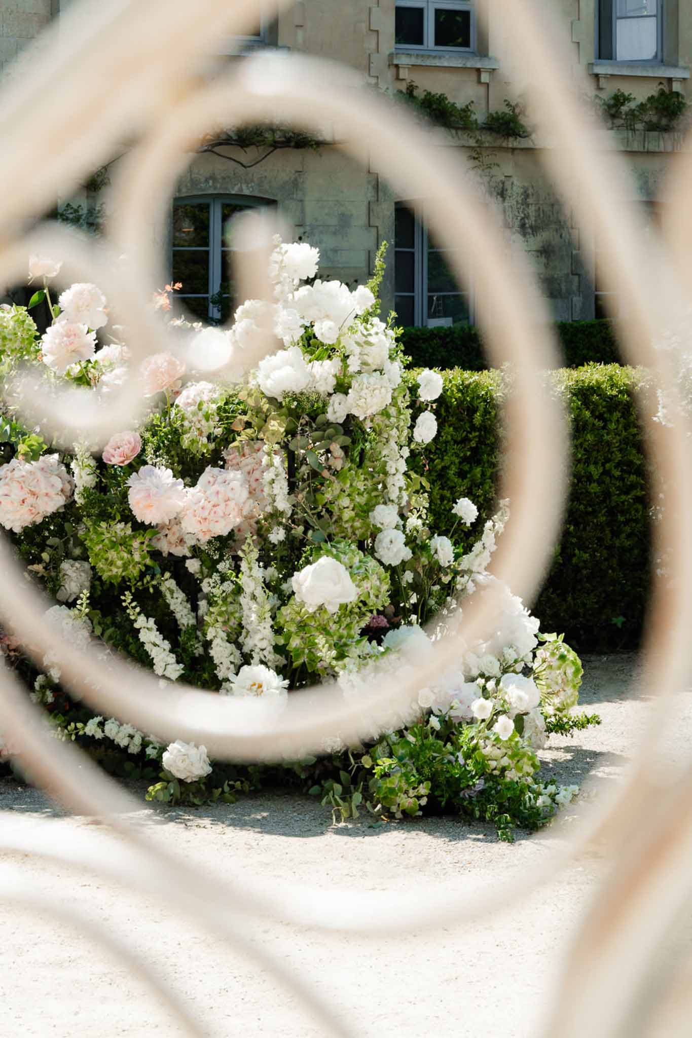 Wedding rings in a garden with white roses