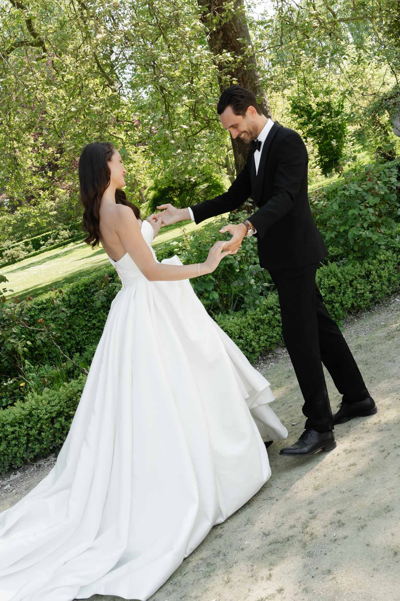 Bride and groom dancing in a garden