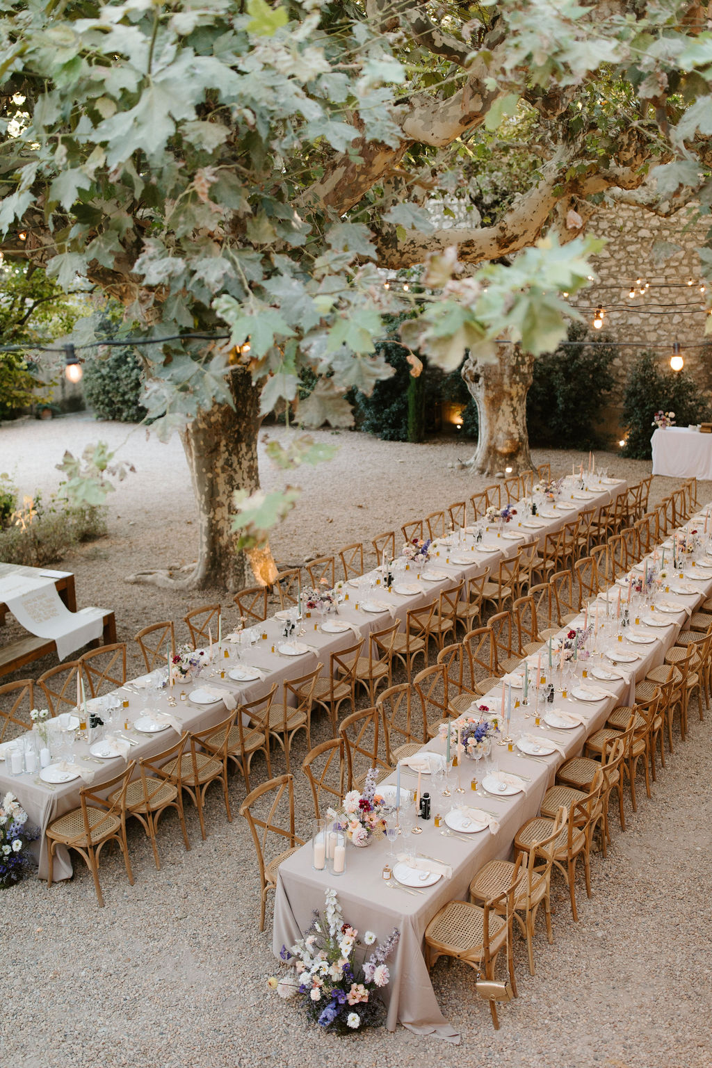 Wedding reception table setting in a garden with white roses