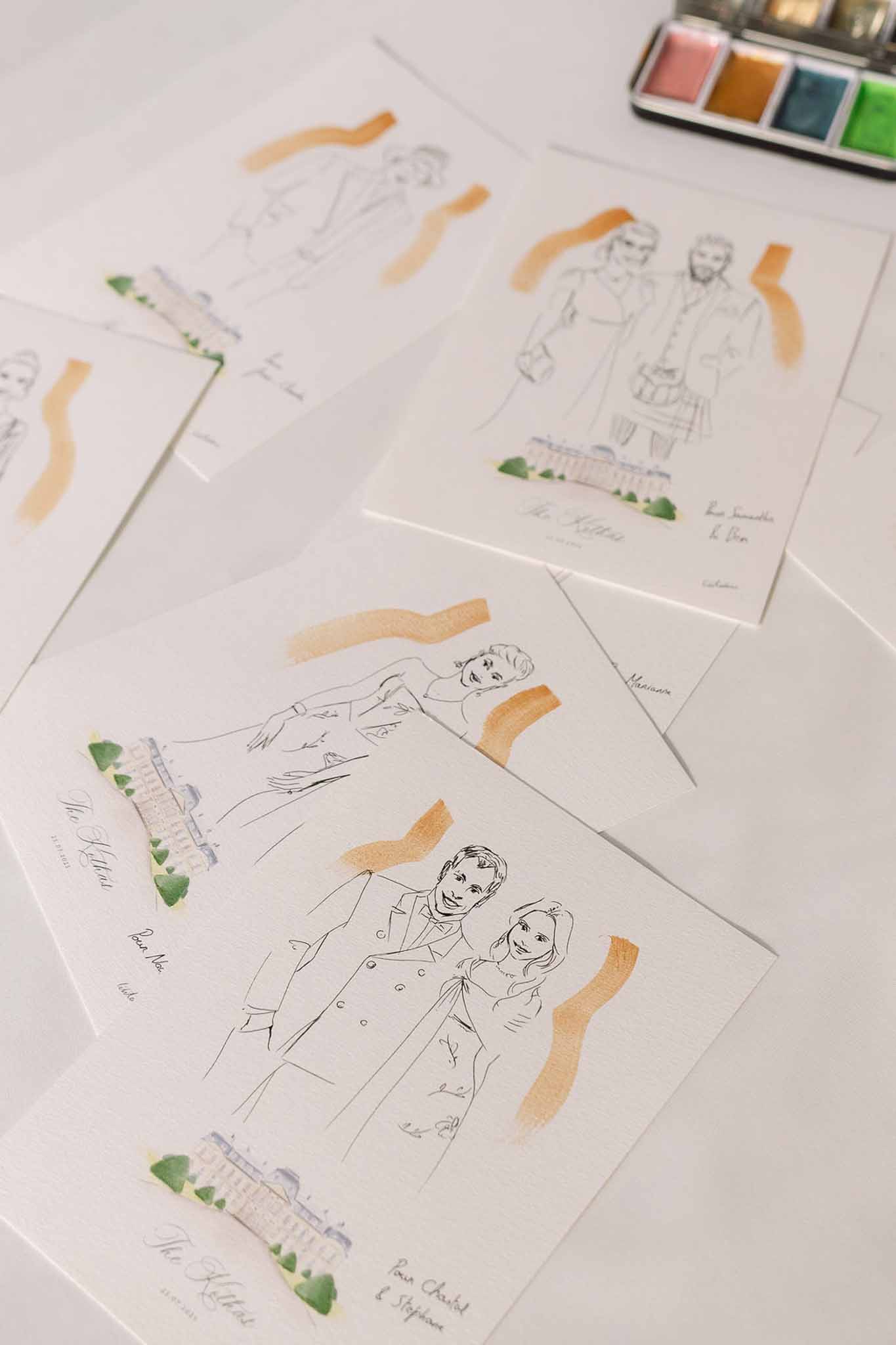 Personalised watercolor portrait illustrations with gold accents spread across white surface