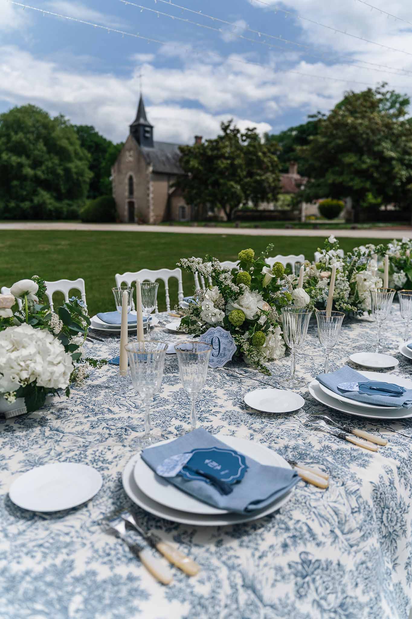 Wedding reception table setting in a chapel with peonies