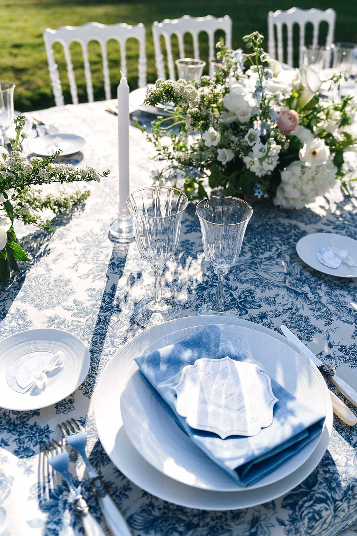 Wedding reception table setting in a garden with white roses