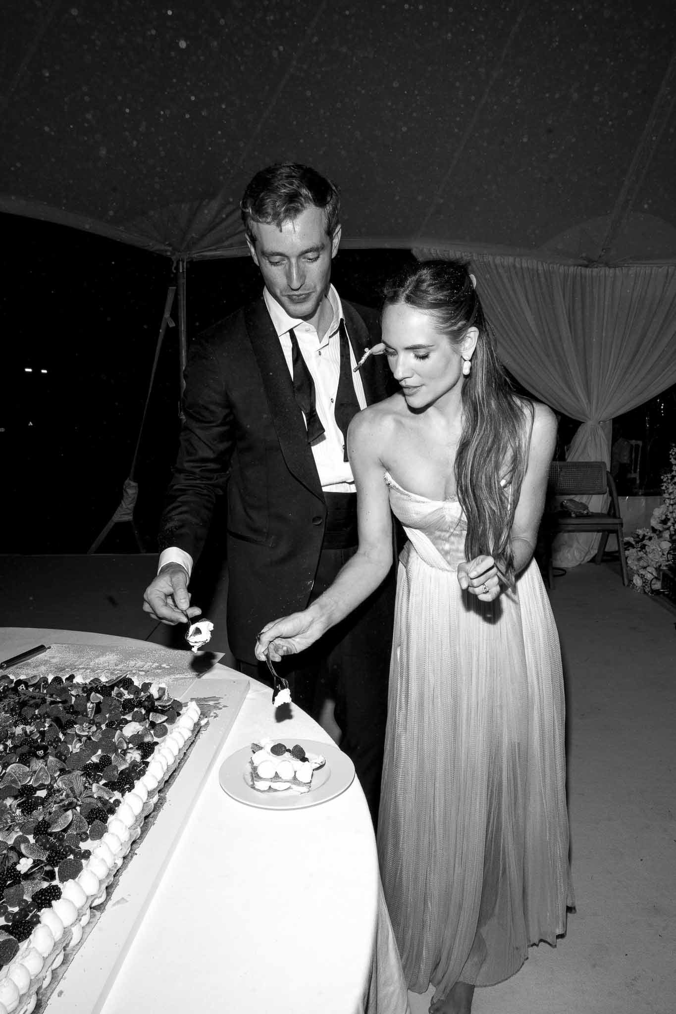 Black and white photo of wedding reception room with white roses
