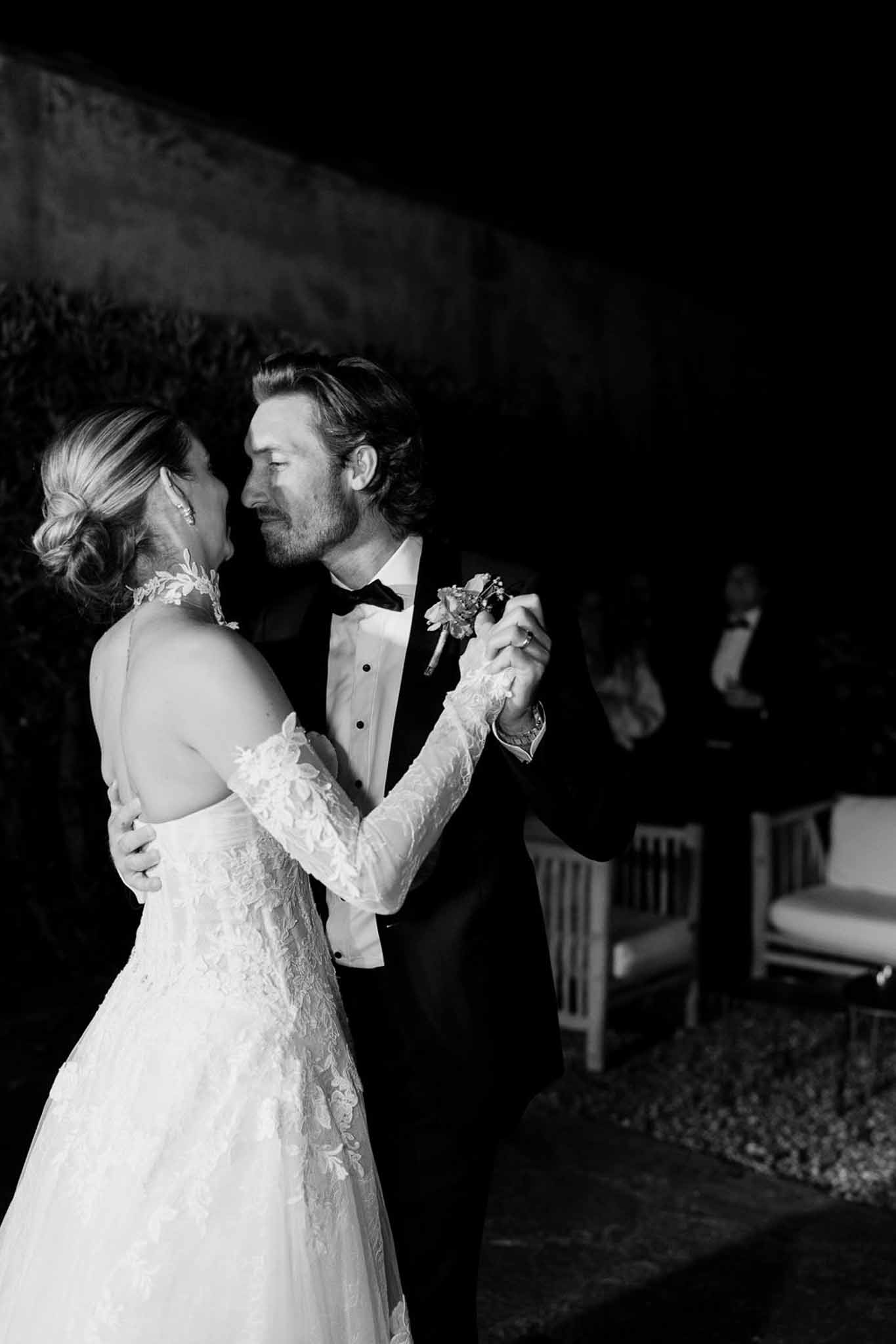 Black and white photo of couple's first dance in a garden