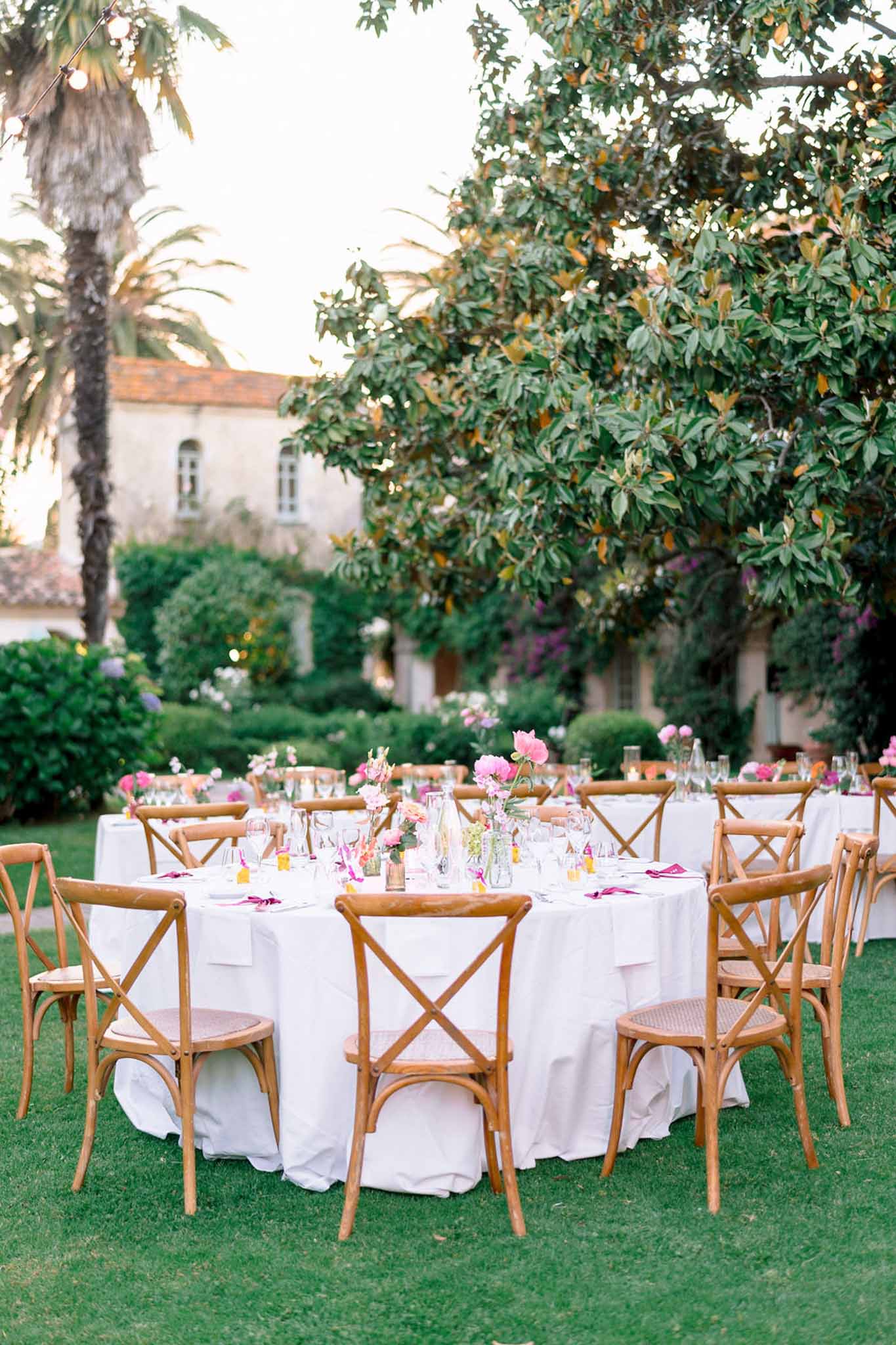 Wedding reception table setting in a garden with peonies