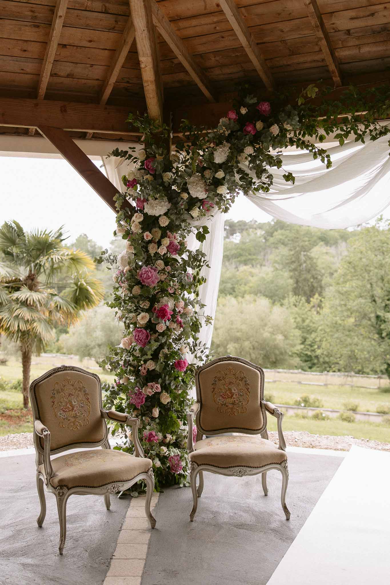 Wedding ceremony setup in a garden with white roses