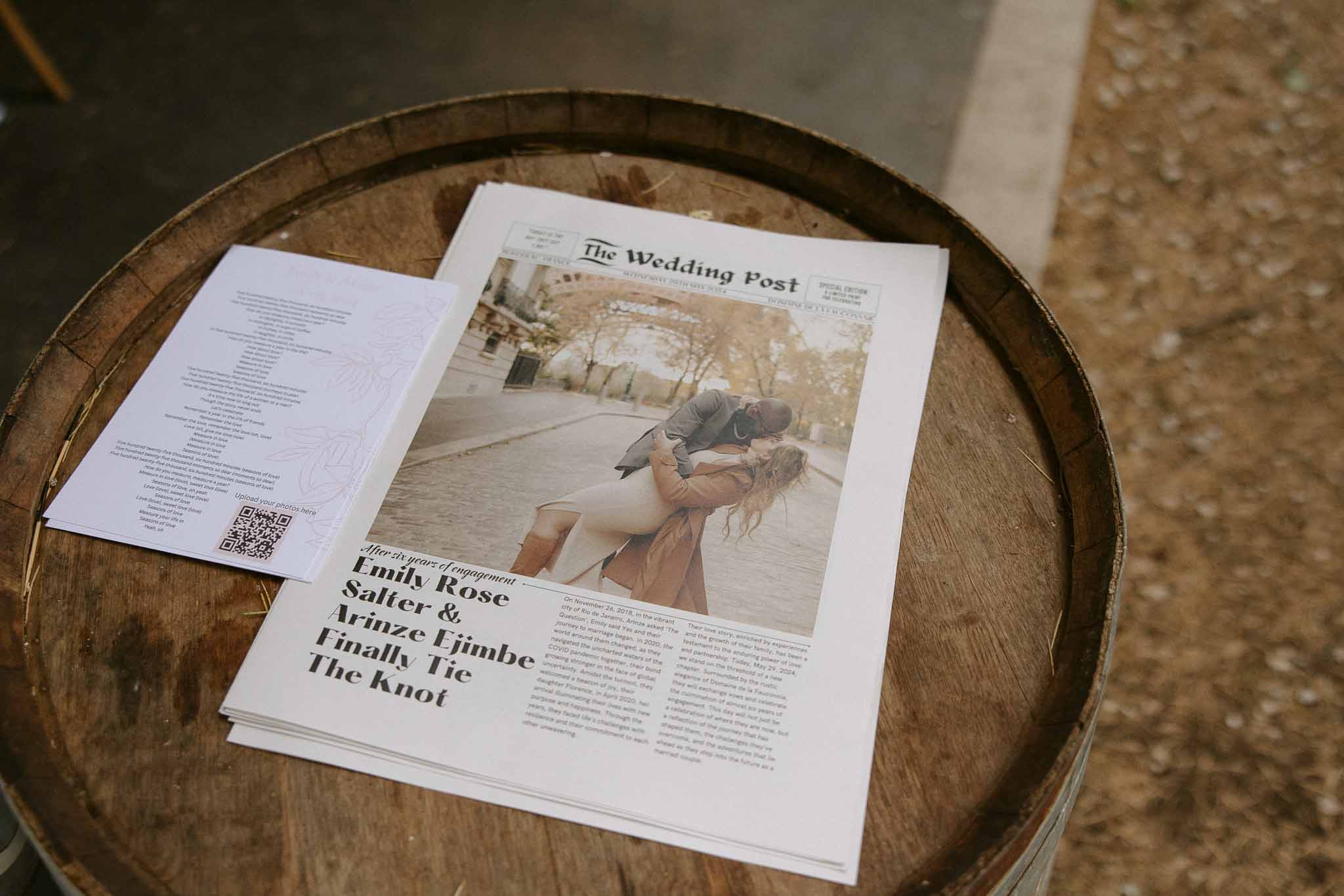 Custom newspaper wedding program titled The Wedding Post displayed on wine barrel