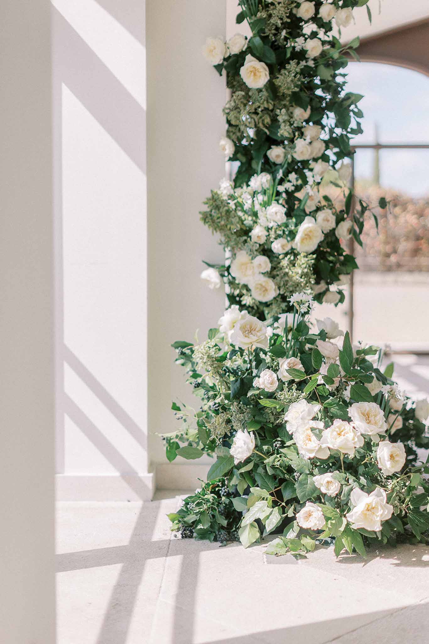 Wedding ceremony setup in a garden with white roses
