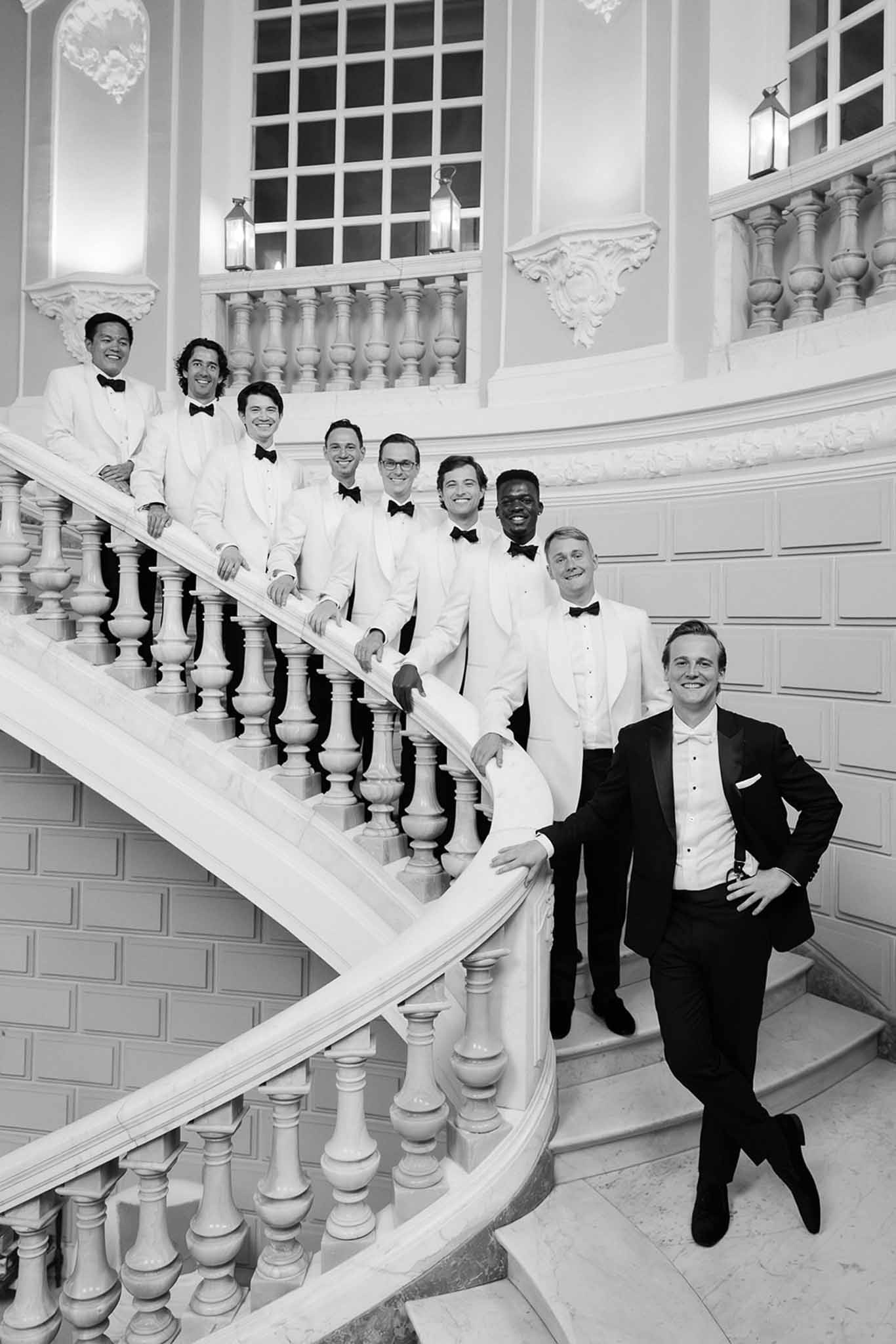 Groom and groomsmen on marble staircase at Domaine Rocabella, Cote d'Azur