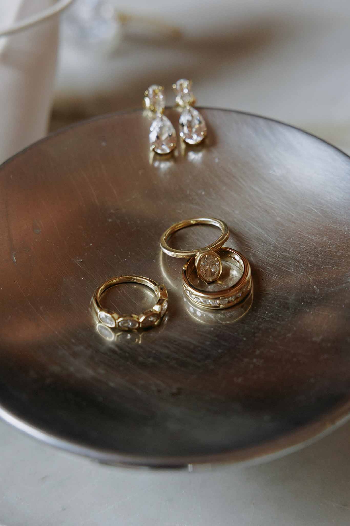 Diamond bridal rings and earrings on bronze dish at Domaine Rocabella, Cote d'Azur