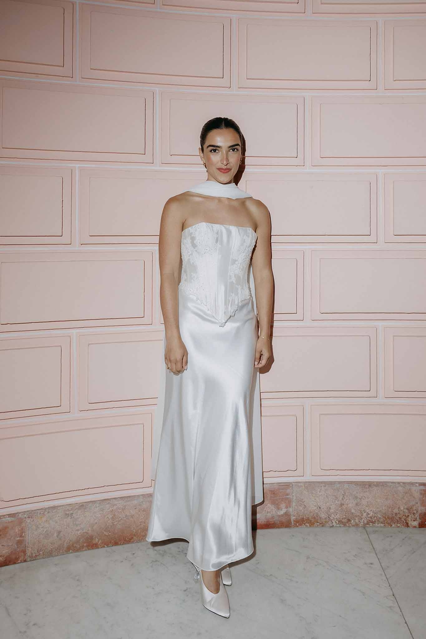 Bride second look silk gown against pink wall at Domaine Rocabella, Cote d'Azur