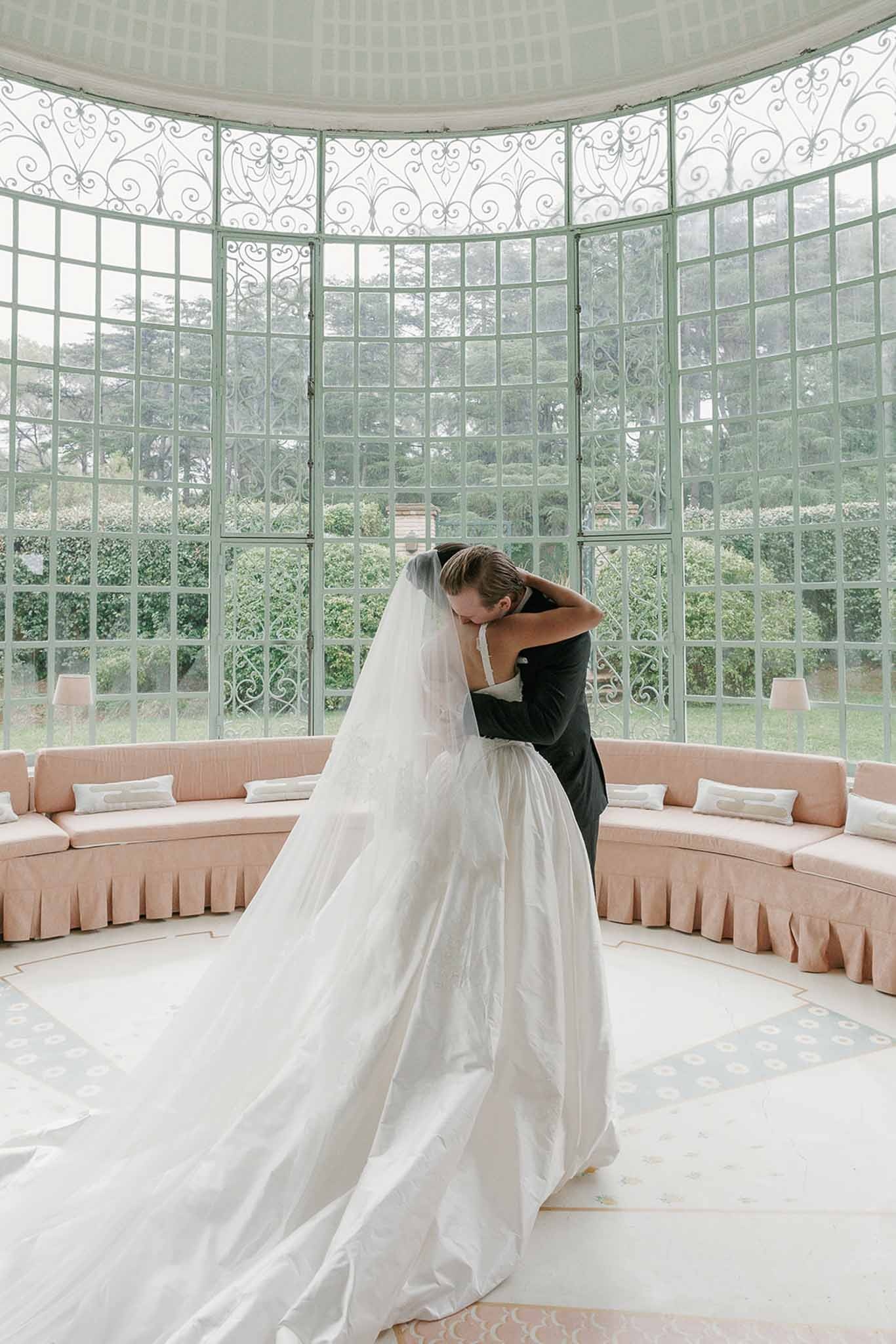 Couple embracing in glass conservatory at Domaine Rocabella, Cote d'Azur