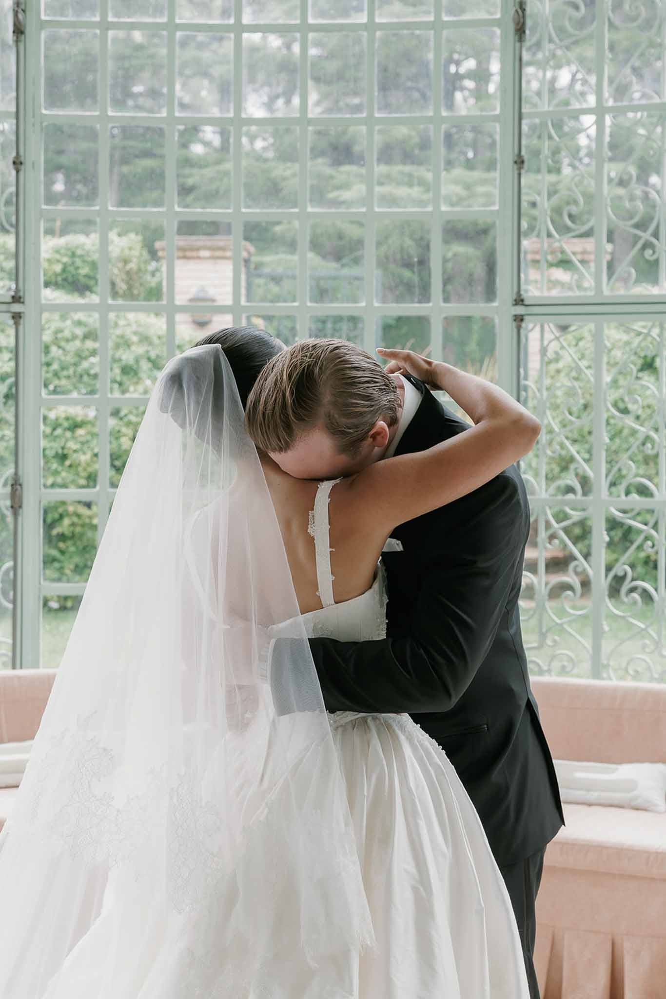 Bride and groom embracing during first look at Domaine Rocabella, Cote d'Azur
