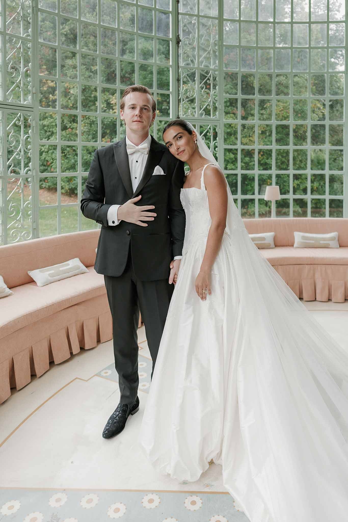 Bride leaning on groom's shoulder in conservatory at Domaine Rocabella, Cote d'Azur
