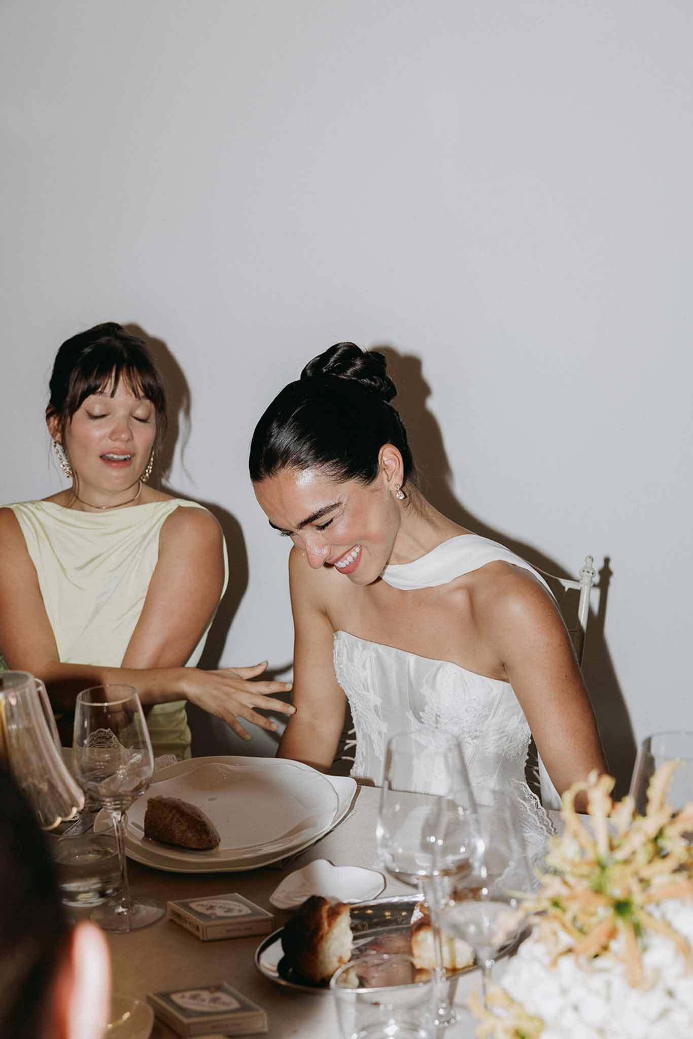 Bride laughing at reception dinner table at Domaine Rocabella, Cote d'Azur