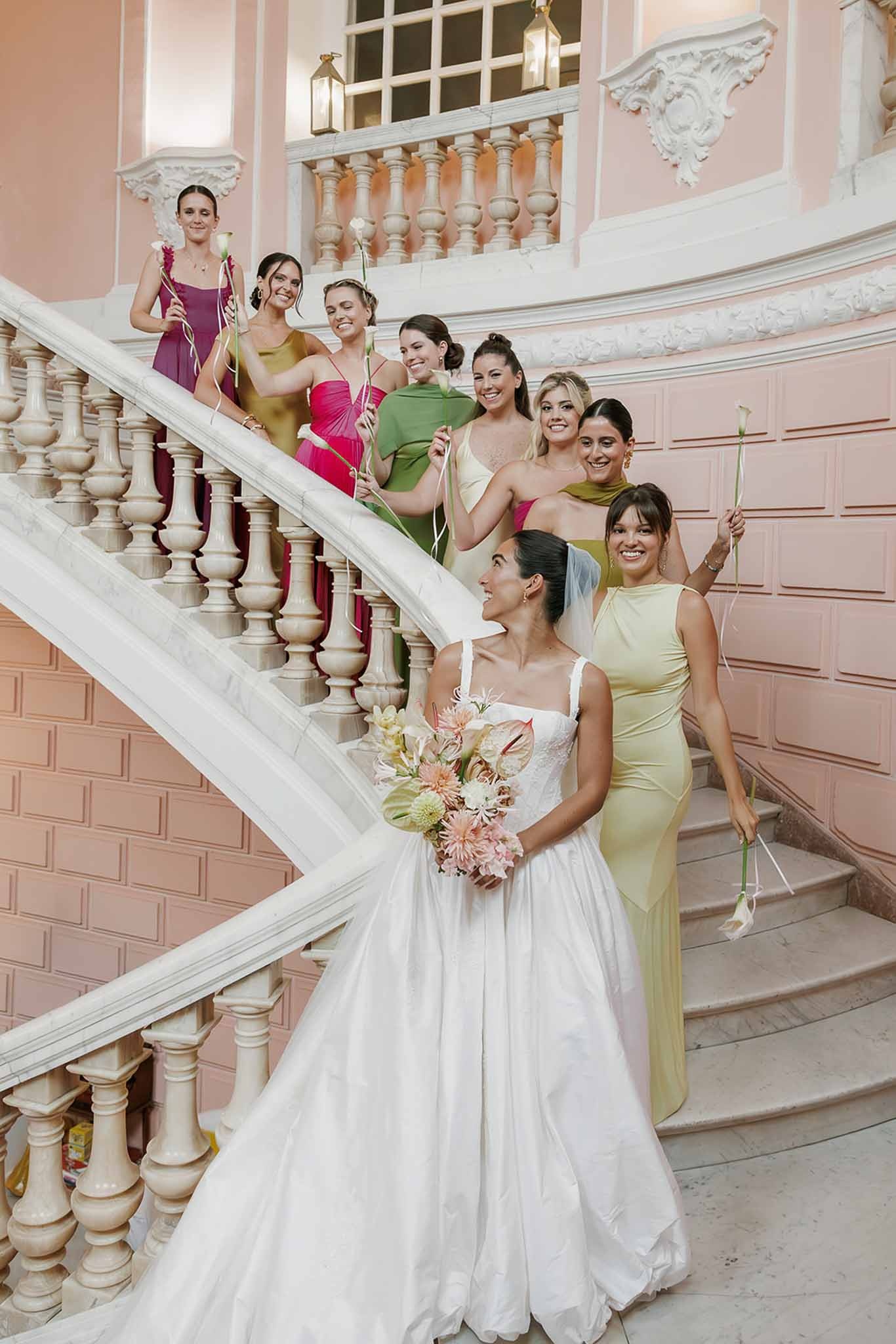 Bride and bridesmaids on pink marble staircase at Domaine Rocabella, Cote d'Azur