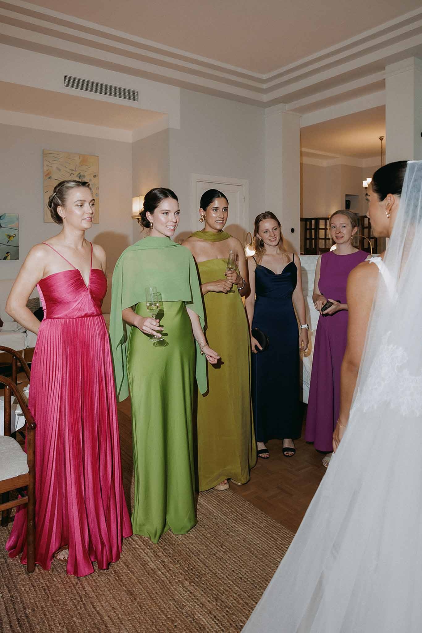 Bridesmaids showing gowns to veiled bride at Domaine Rocabella, Cote d'Azur