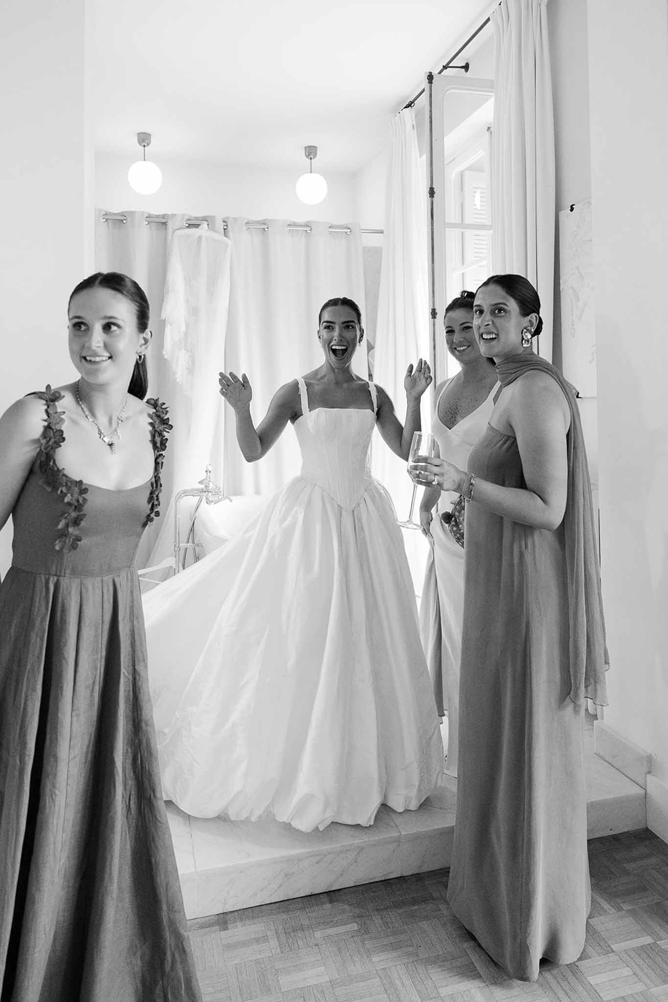 Bride reacting as bridesmaids see her dress at Domaine Rocabella, Cote d'Azur