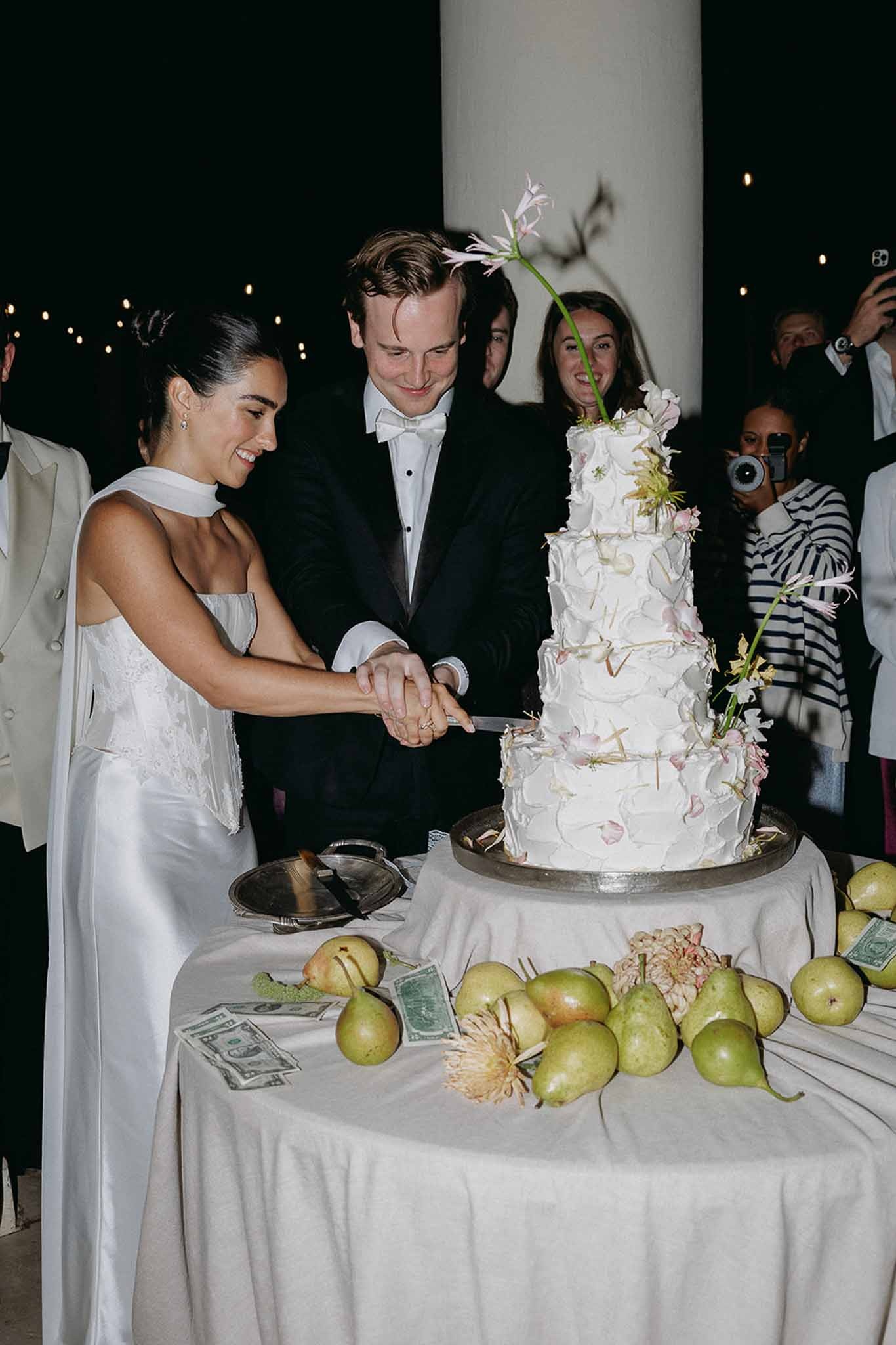 Couple cutting four-tier wedding cake at Domaine Rocabella, Cote d'Azur