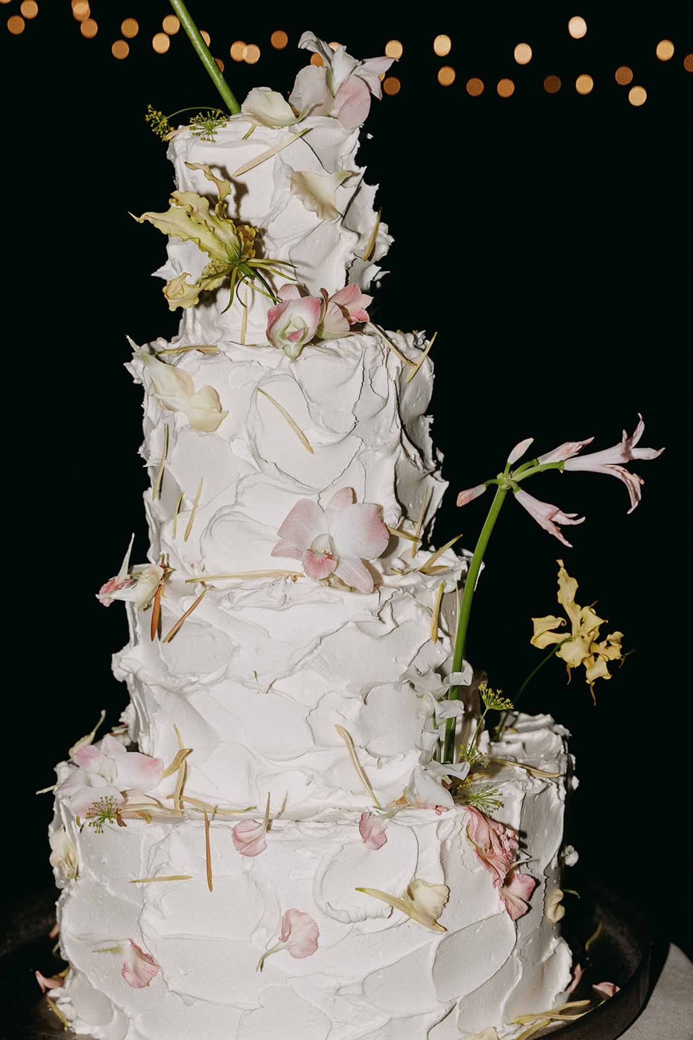 Ruffled buttercream cake with blush and yellow florals at Domaine Rocabella, Cote d'Azur