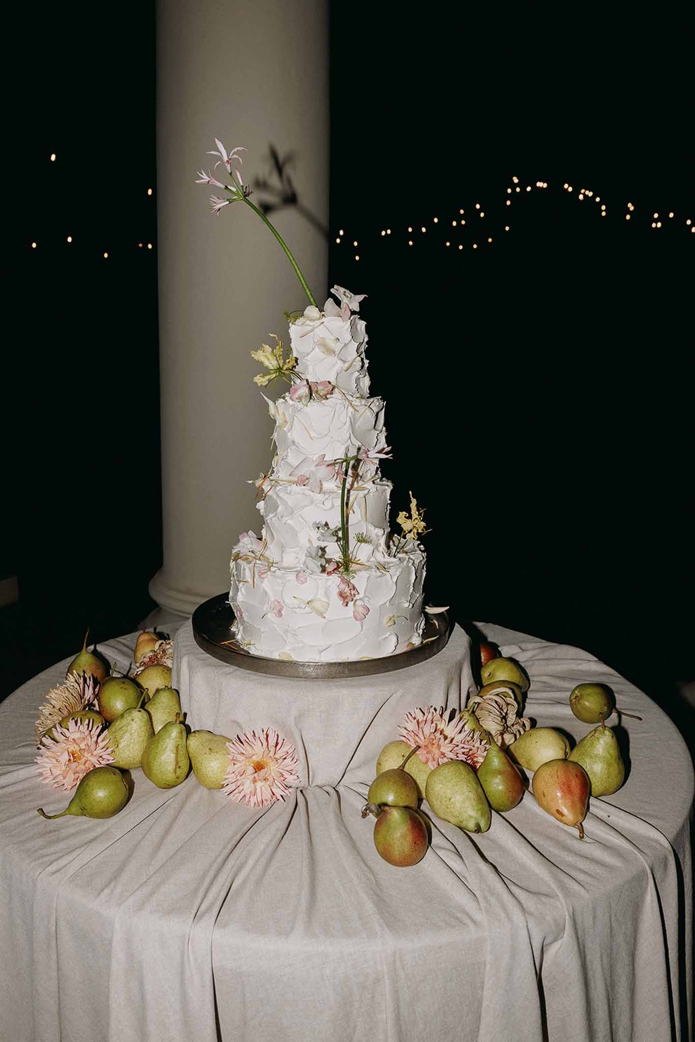 Four-tier cake with pears and dahlias on linen table at Domaine Rocabella, Cote d'Azur