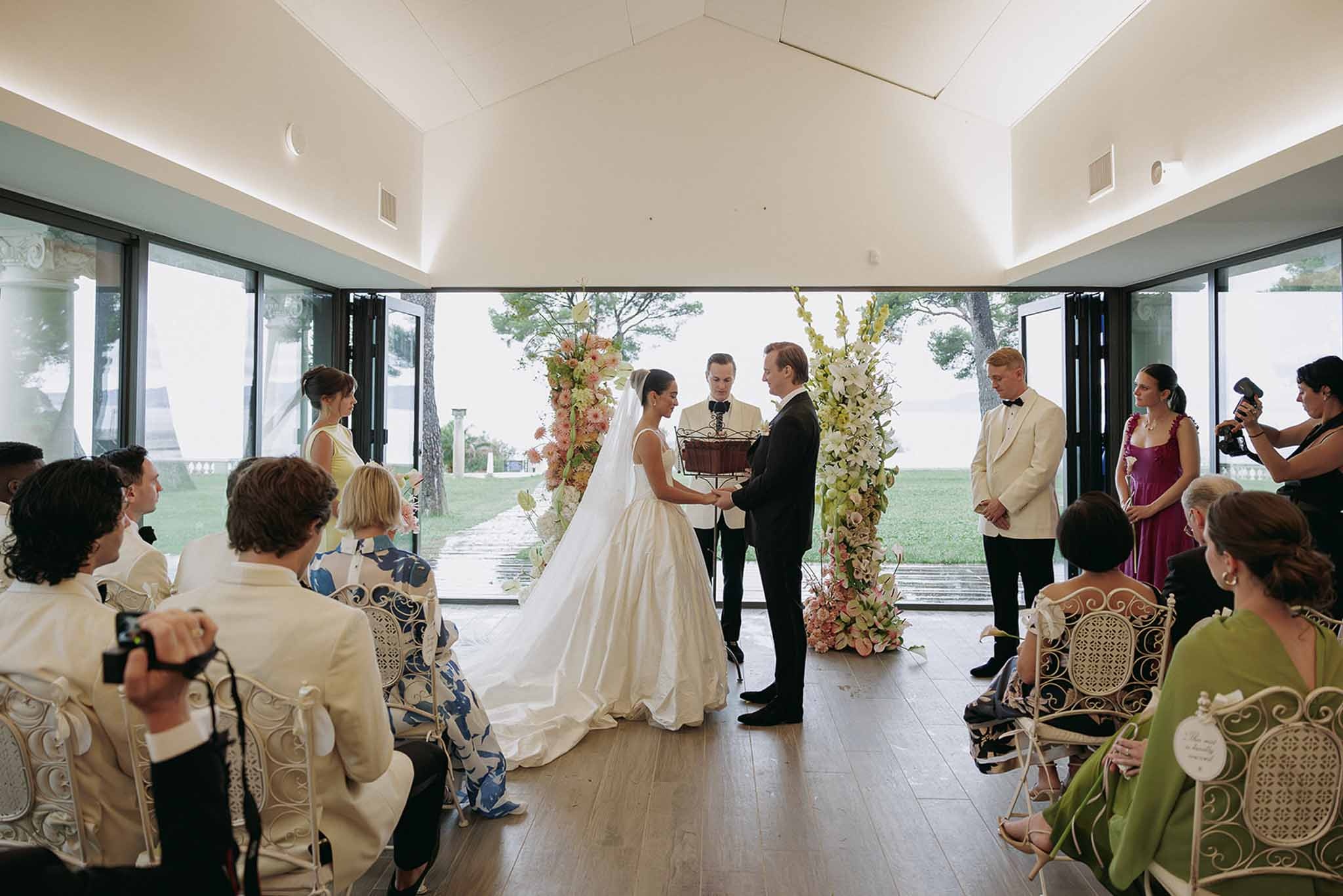 Glass pavilion ceremony with guests and sea view at Domaine Rocabella, Cote d'Azur