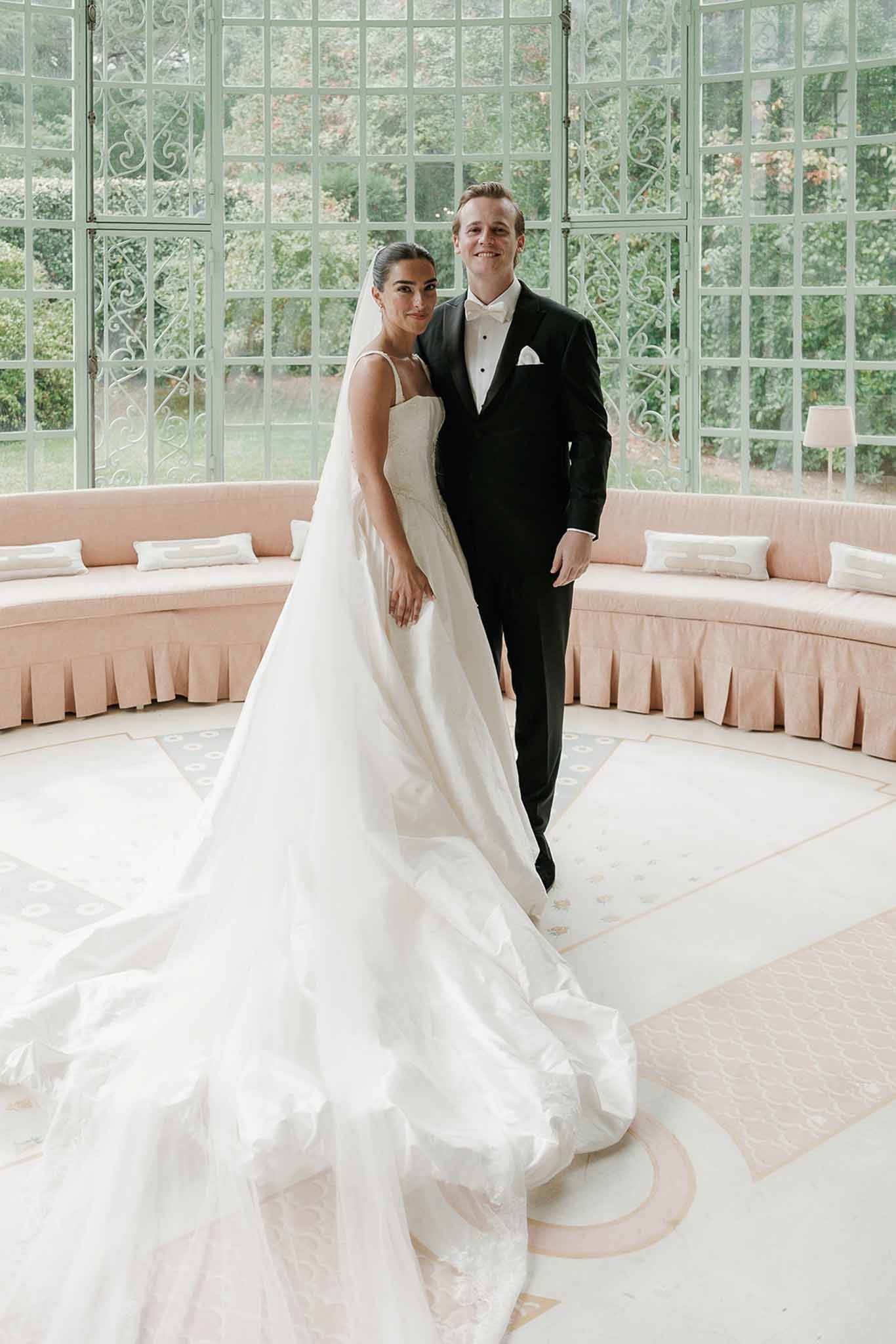 Couple portrait in glass conservatory with long veil at Domaine Rocabella, Cote d'Azur