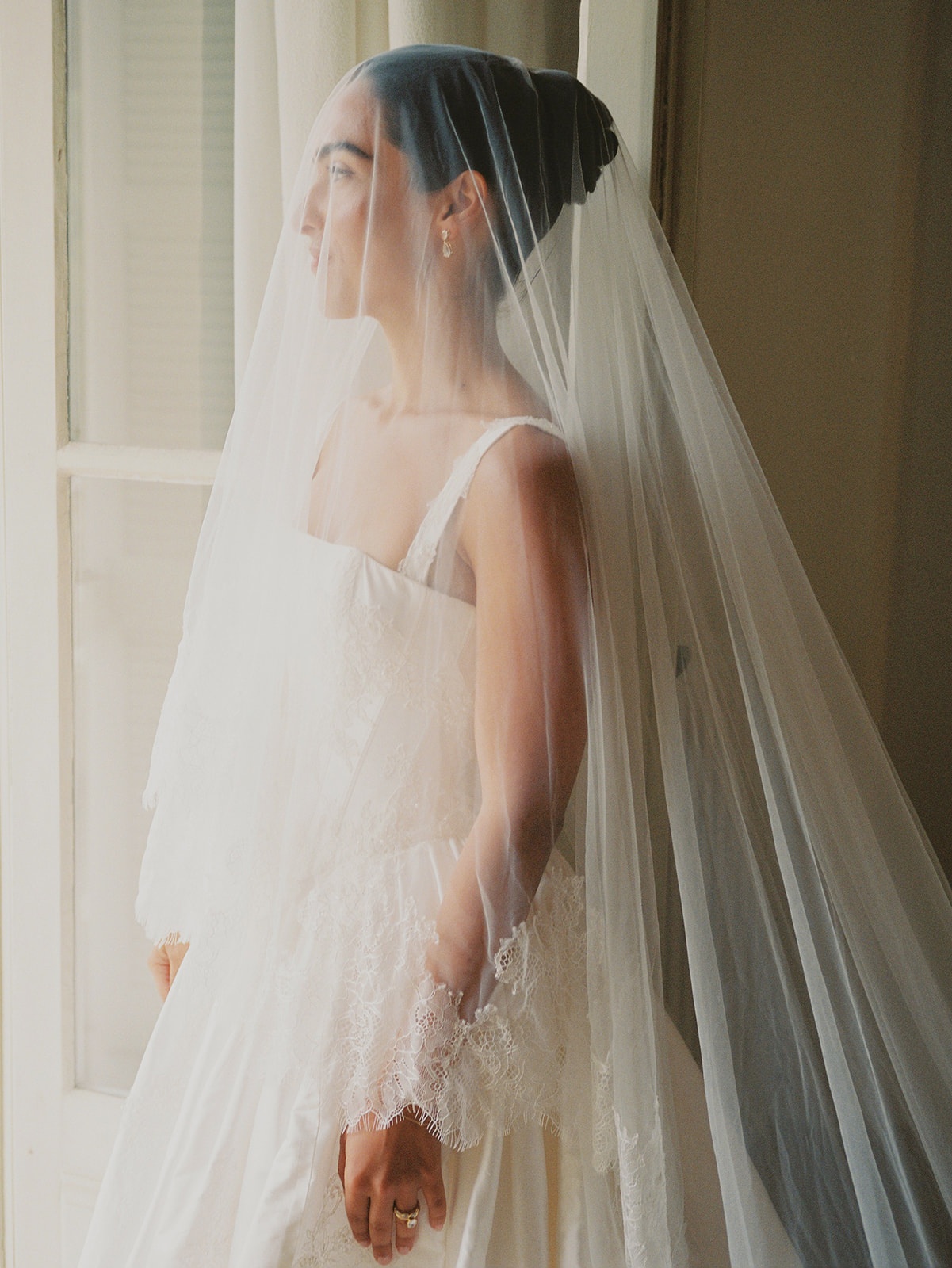 Bride with veil in window light at Domaine Rocabella