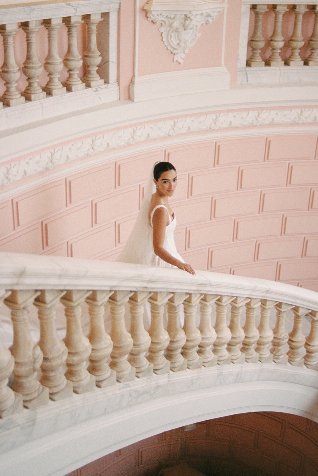 Bride on pink marble staircase at Domaine Rocabella