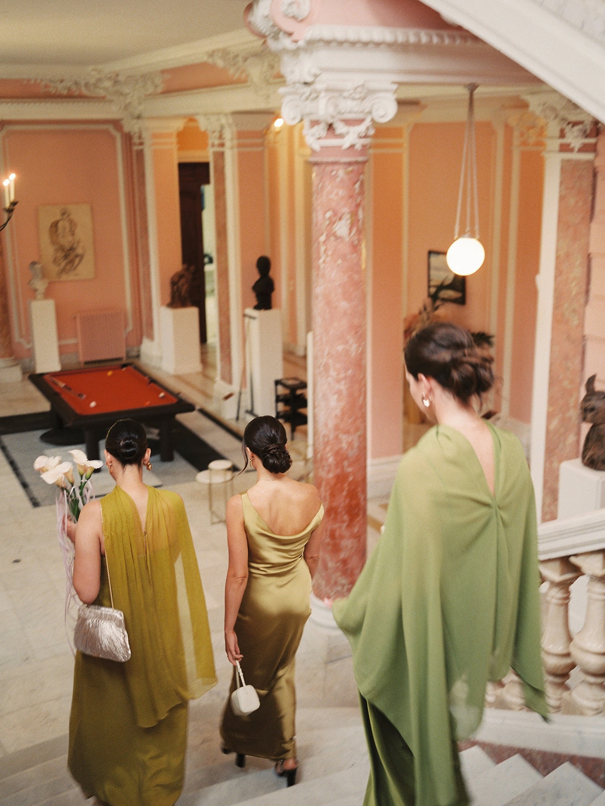 Bridesmaids descending marble staircase at Domaine Rocabella