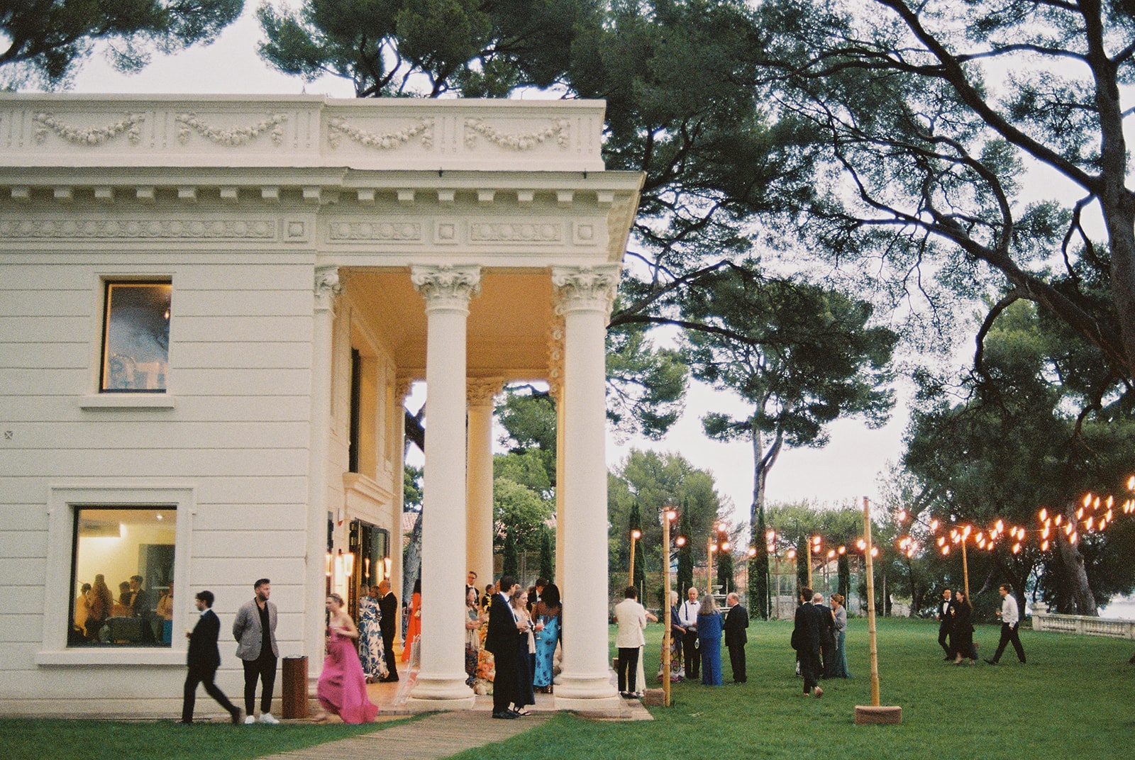 Cocktail hour on lawn at Domaine Rocabella at dusk