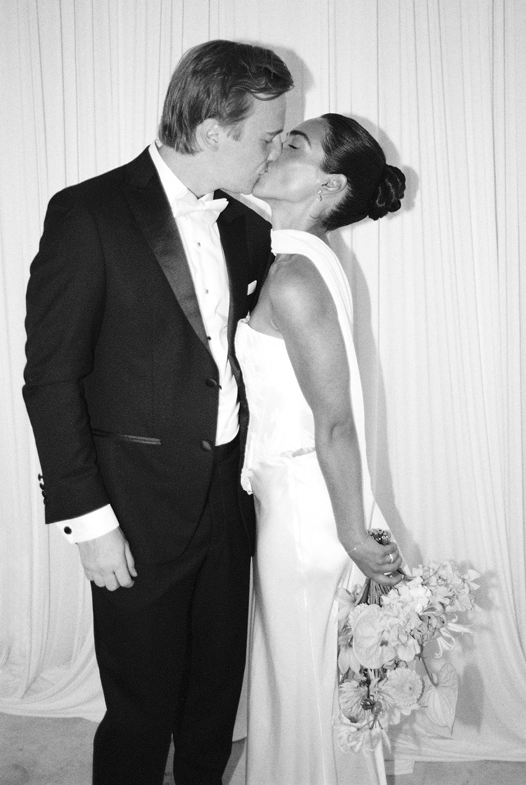 Couple kissing in evening gown at Domaine Rocabella