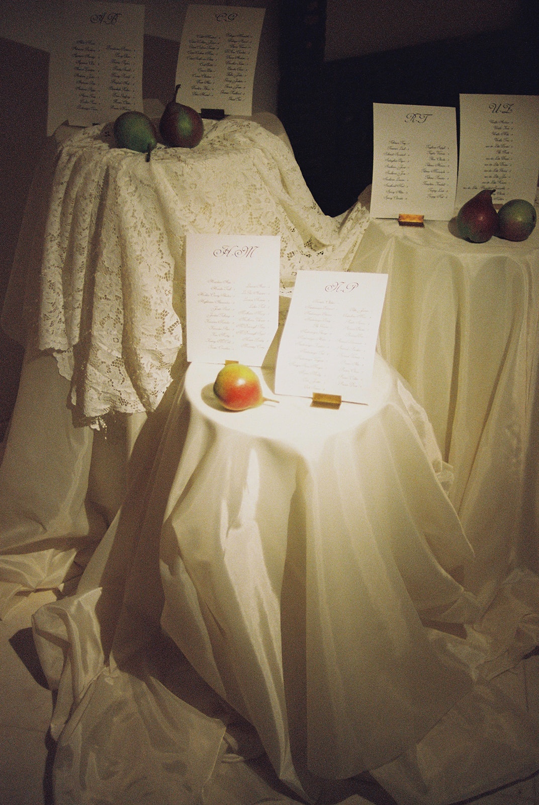 Draped seating chart display with pears at Domaine Rocabella