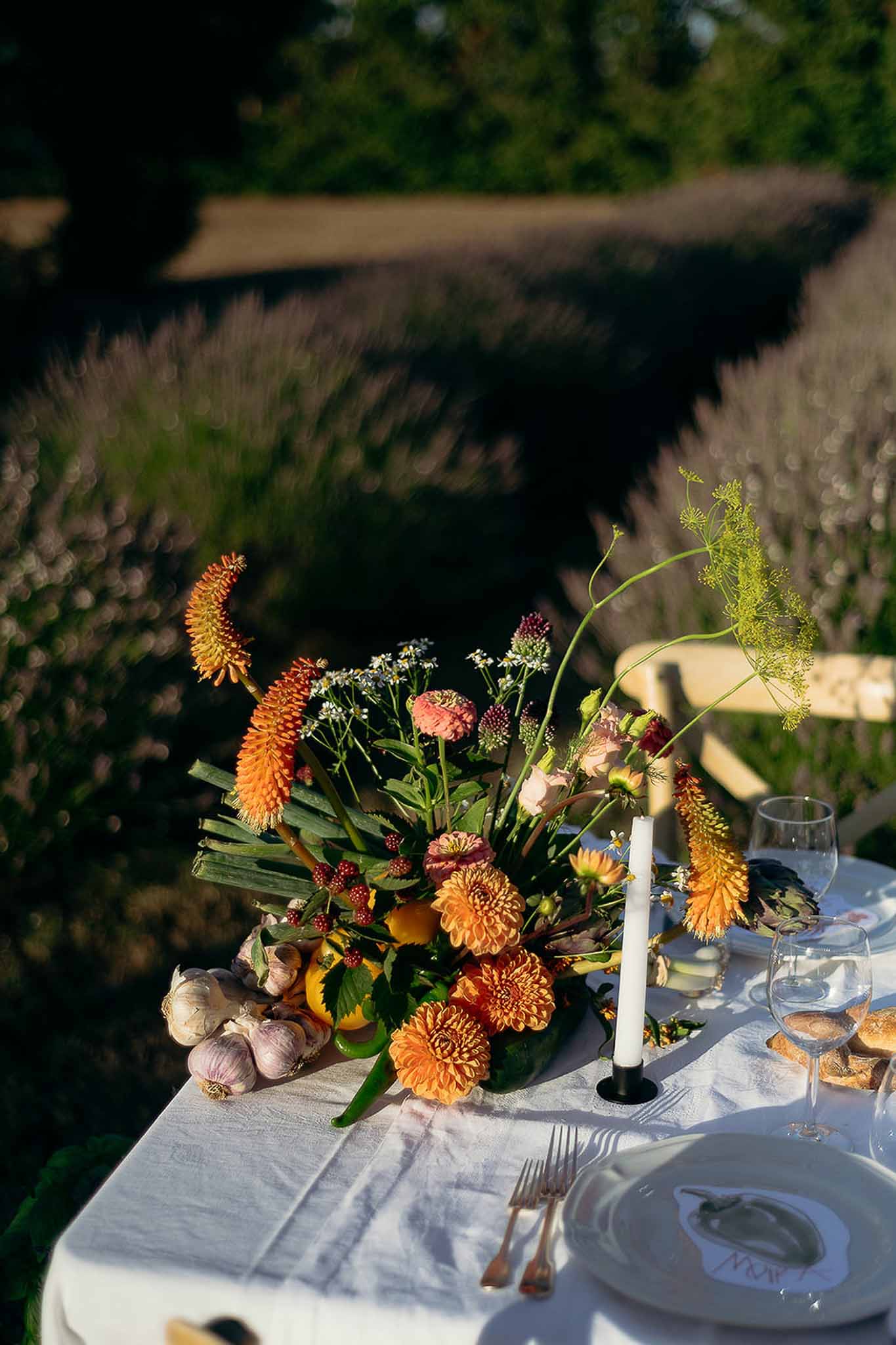 Market-inspired centerpiece with vegetables, flowers and candles, Bastide des Barattes styled shoot