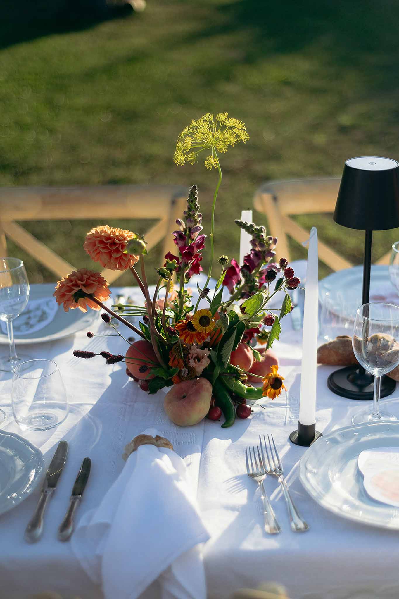 Centerpiece with vegetables, flowers, lamp and candles creating warm ambiance, Bastide des Barattes