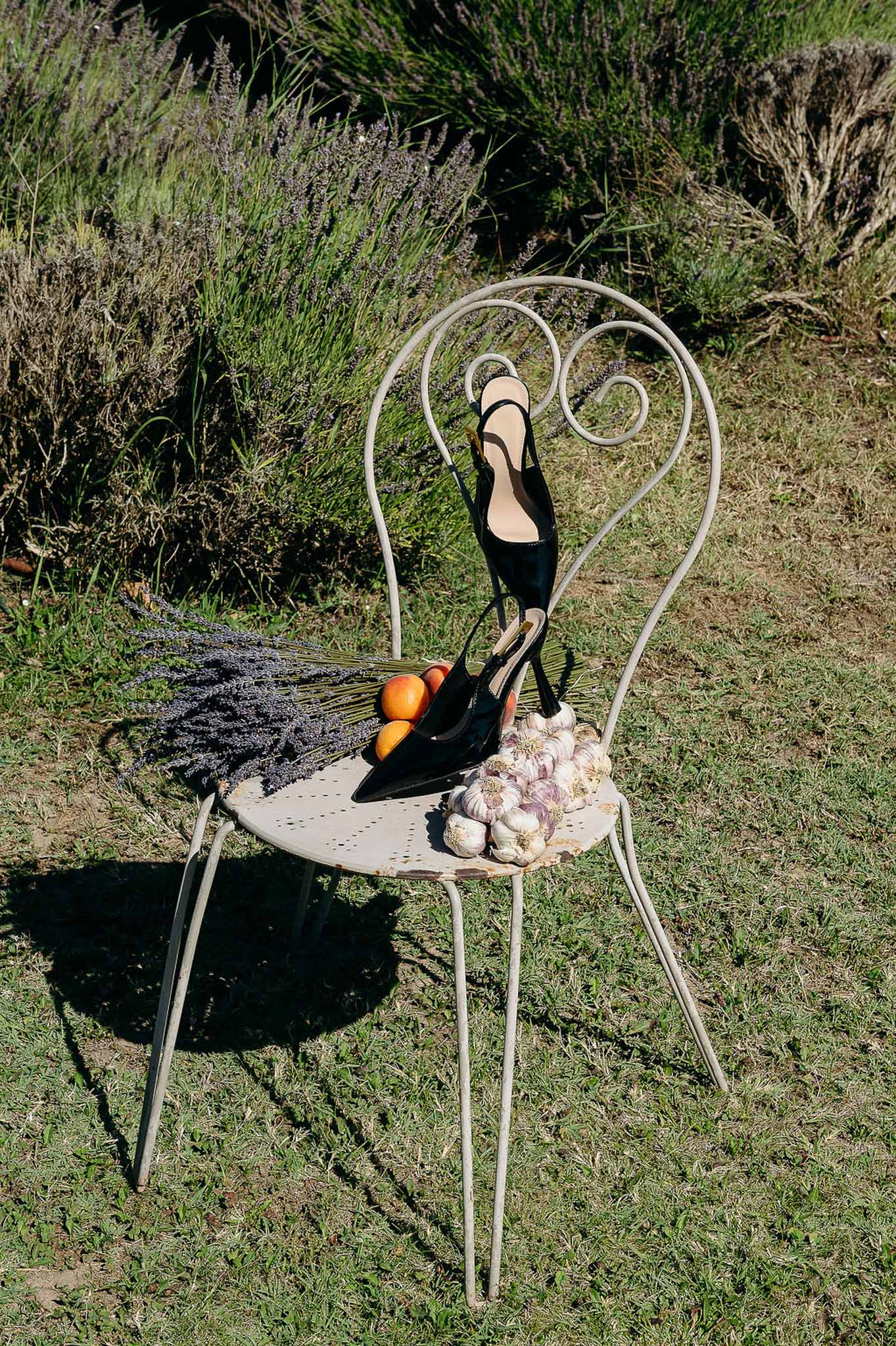 Bride's pointed shoes detail shot on vintage wooden chair, Bastide des Barattes styled shoot