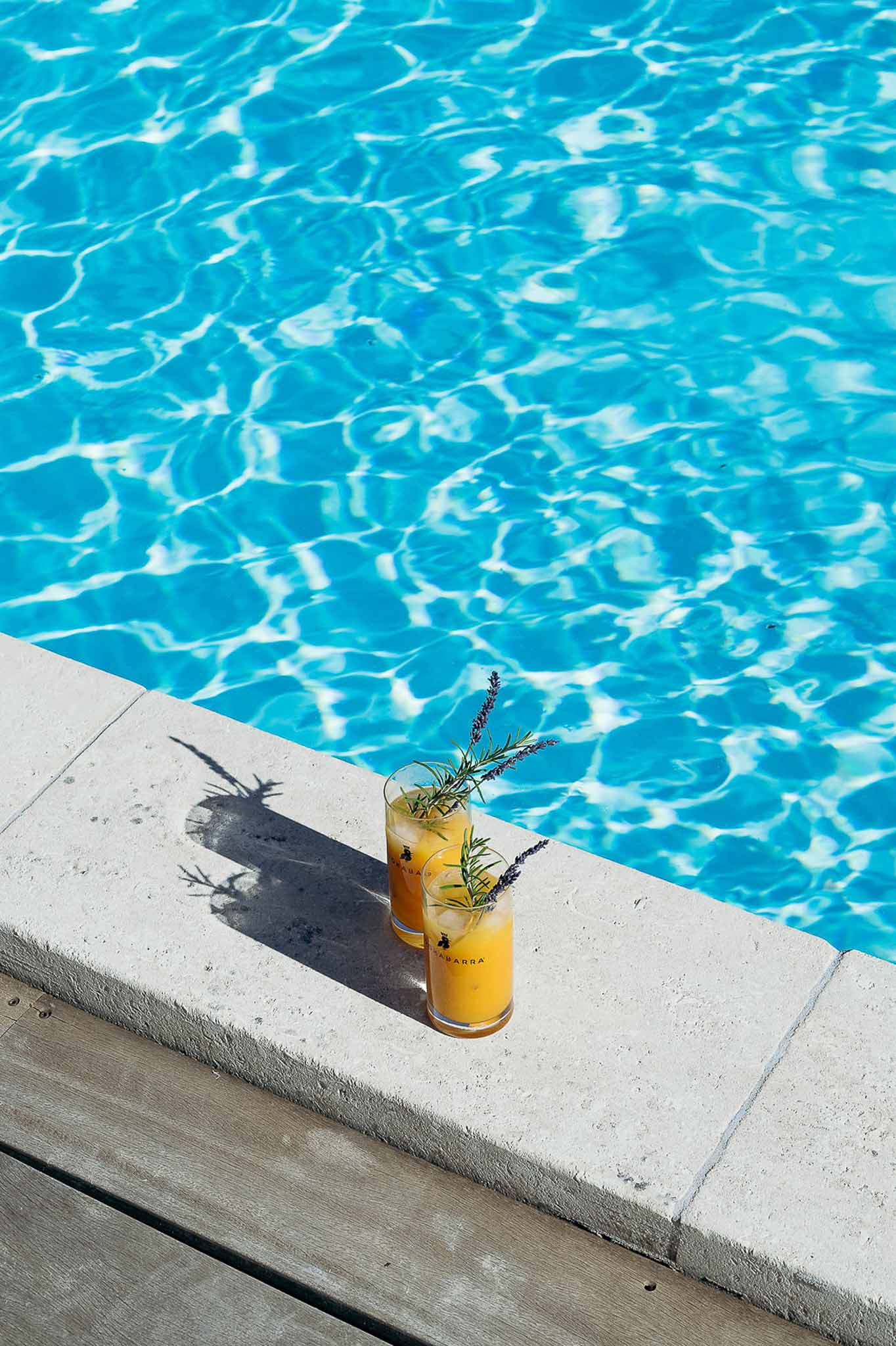 Drinks served poolside at golden hour, Bastide des Barattes Provence summer evening