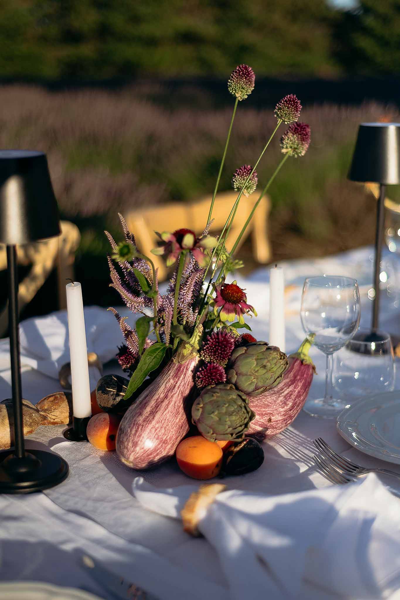 Golden hour lamp and floral centerpiece with seasonal produce, Bastide des Barattes market table
