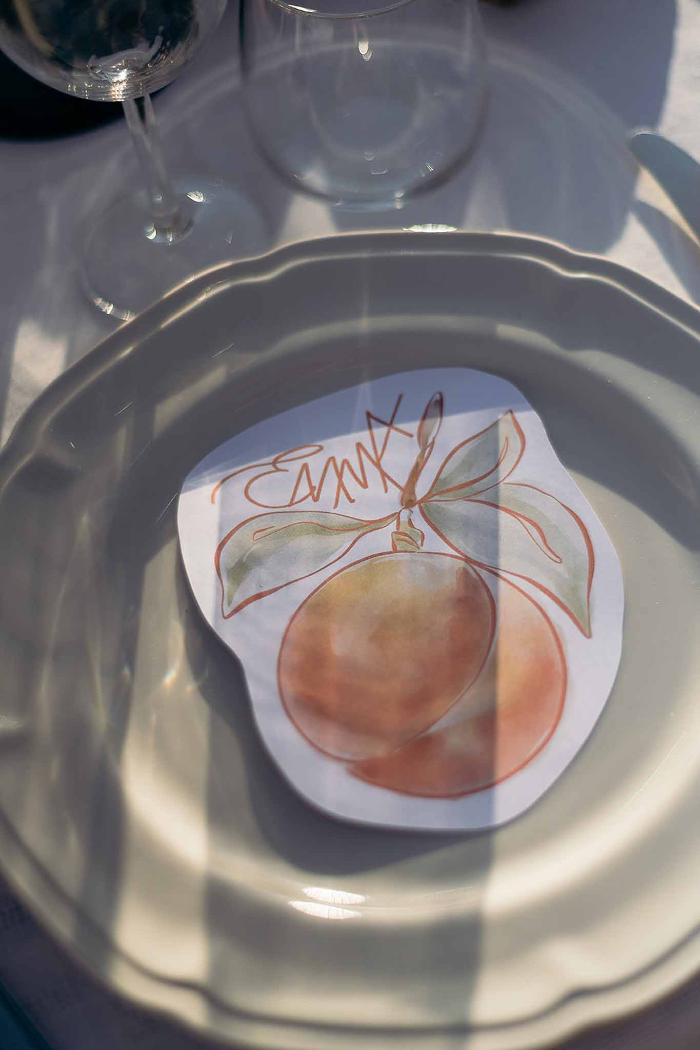 Place card and plate setting at golden hour, graphic stationery on the market reception table, Bastide des Barattes