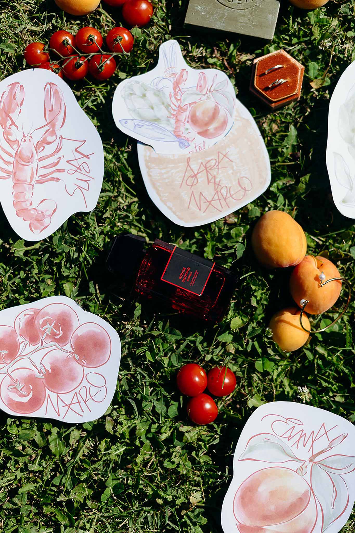 Flat lay of perfume, food and accessories on grass, Bastide des Barattes Provençal styling