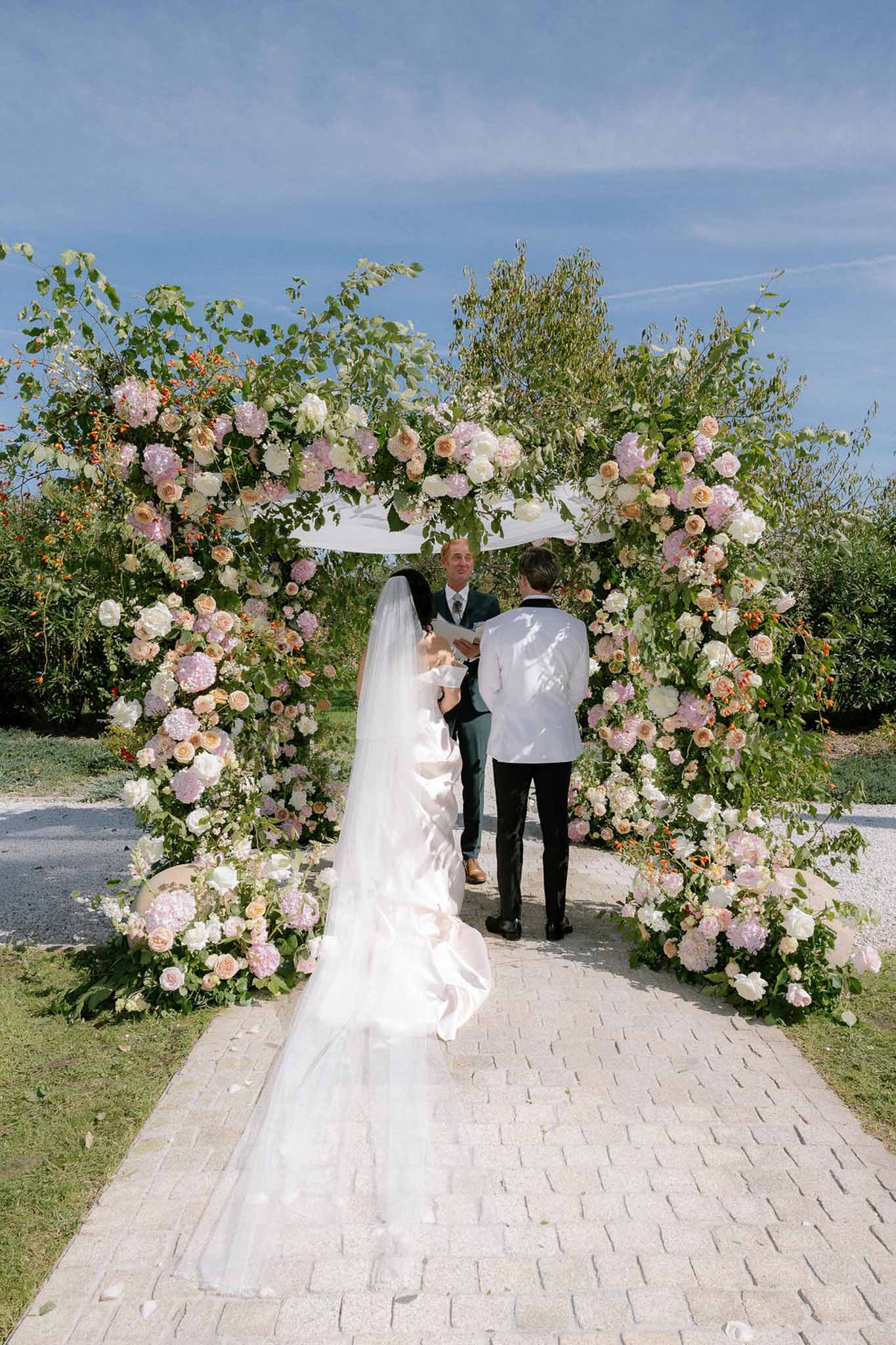 Wedding ceremony in a garden with white roses