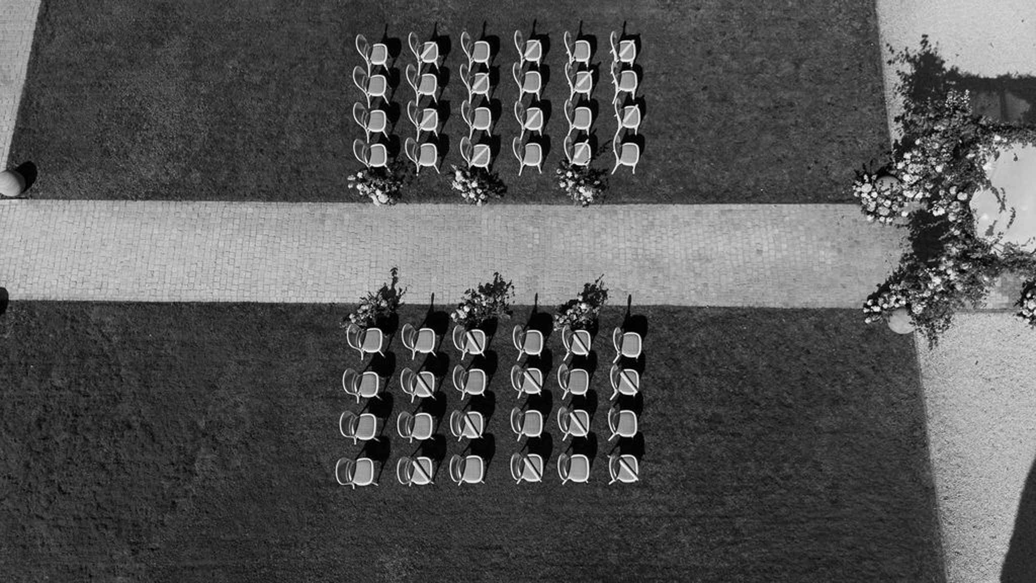 Black and white photo of wedding ceremony setup with white roses