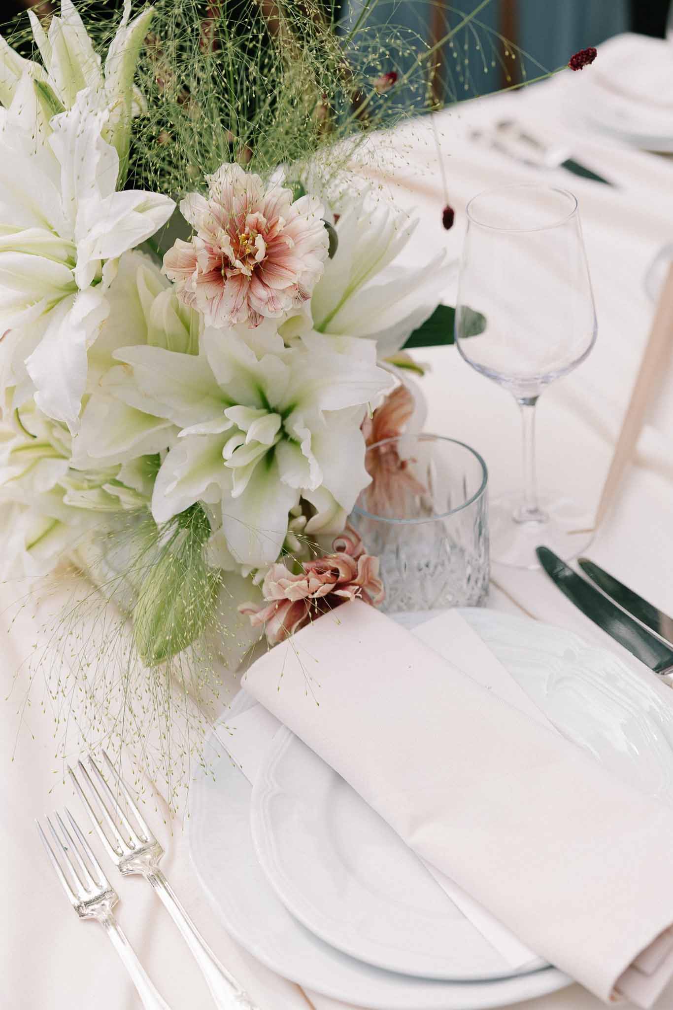 Wedding reception table setting with white roses