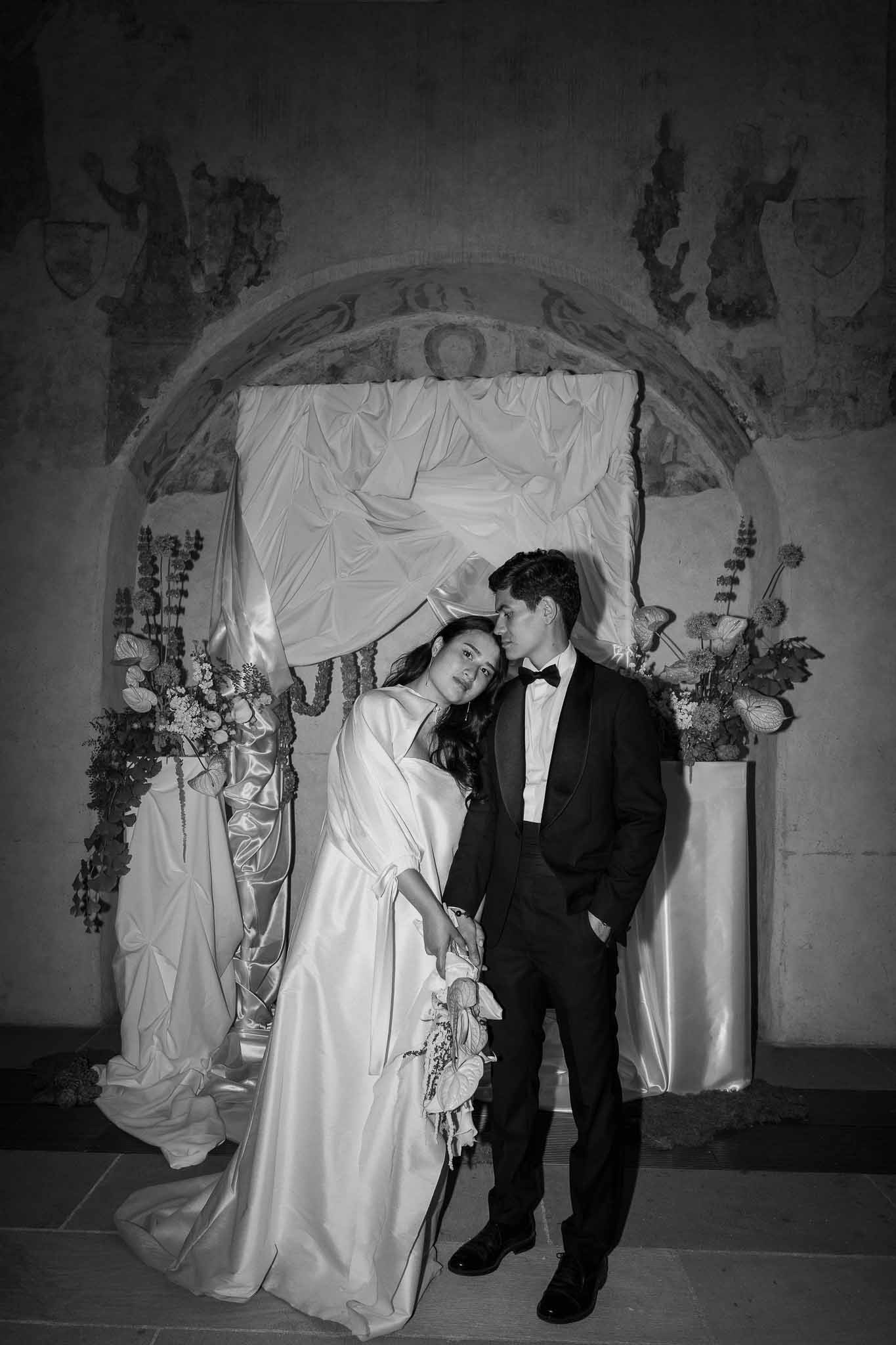 Black and white photo of bride and groom portrait in a chapel